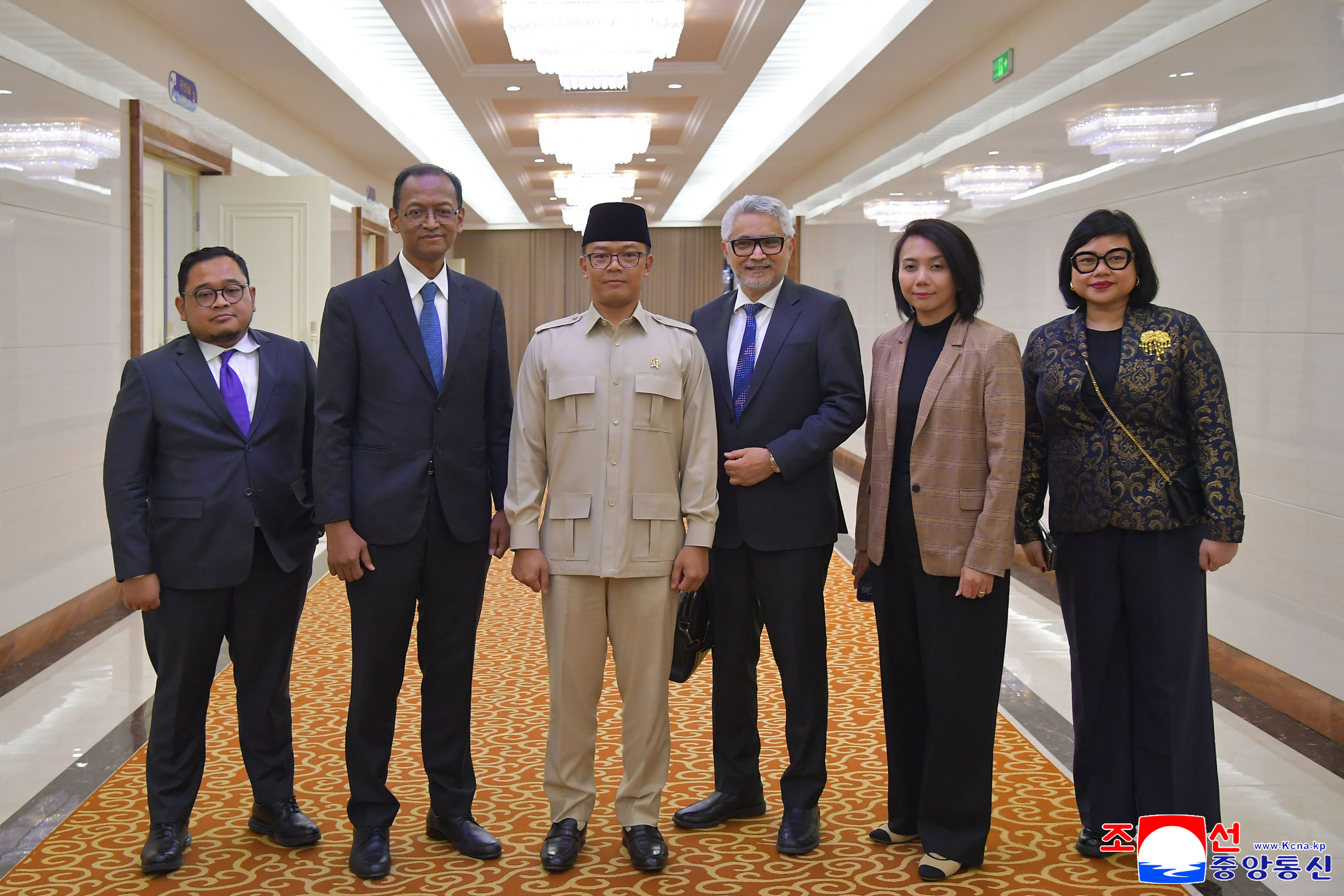 Indonesian Foreign Minister Sugiono (wearing beige) and his delegation arrive in Pyongyang on Friday. Photo: Korean Central News Agency/Korea News Service via AP