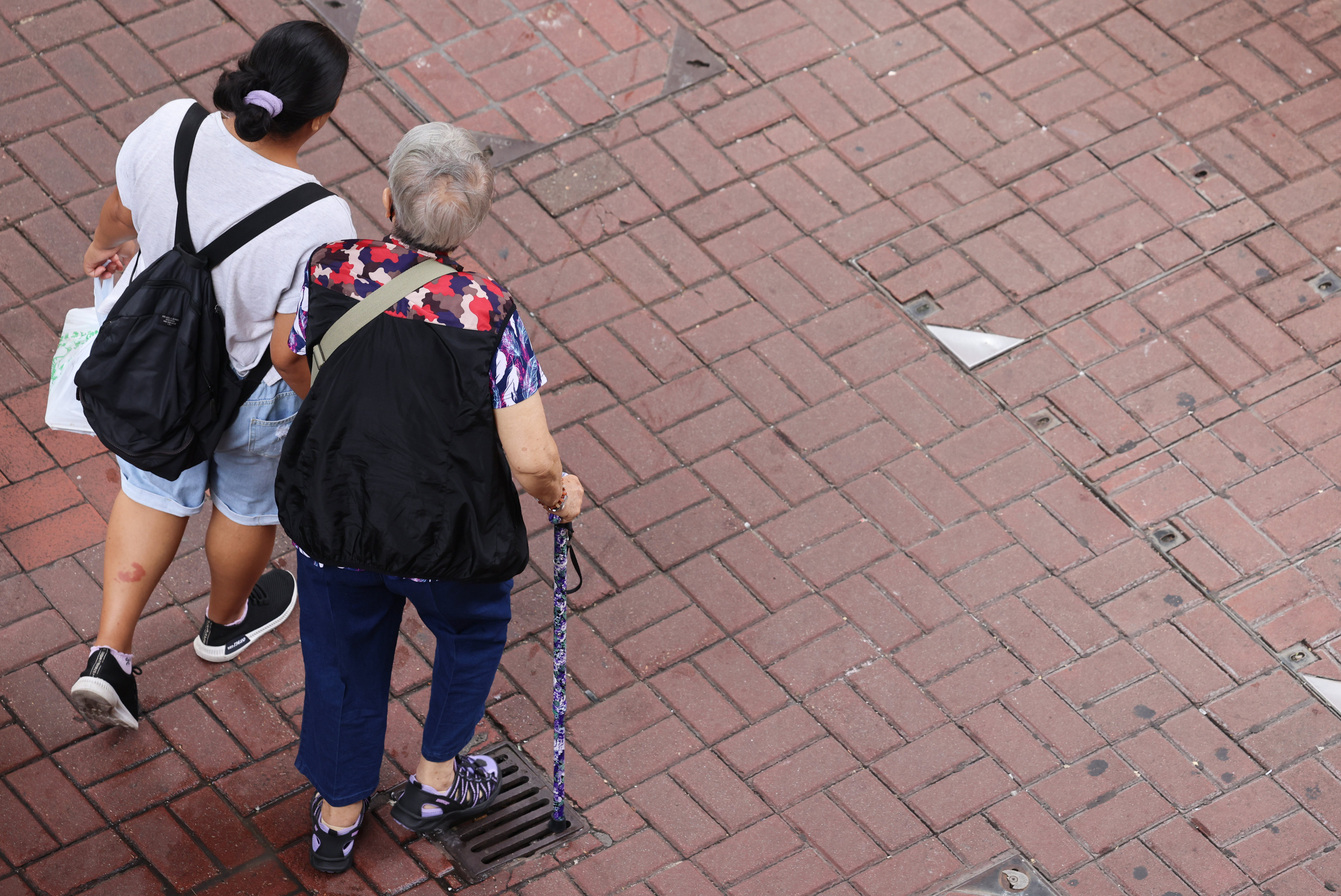 Two people, including a senior resident, walk through Mong Kok on October 10. Photo: Jelly Tse