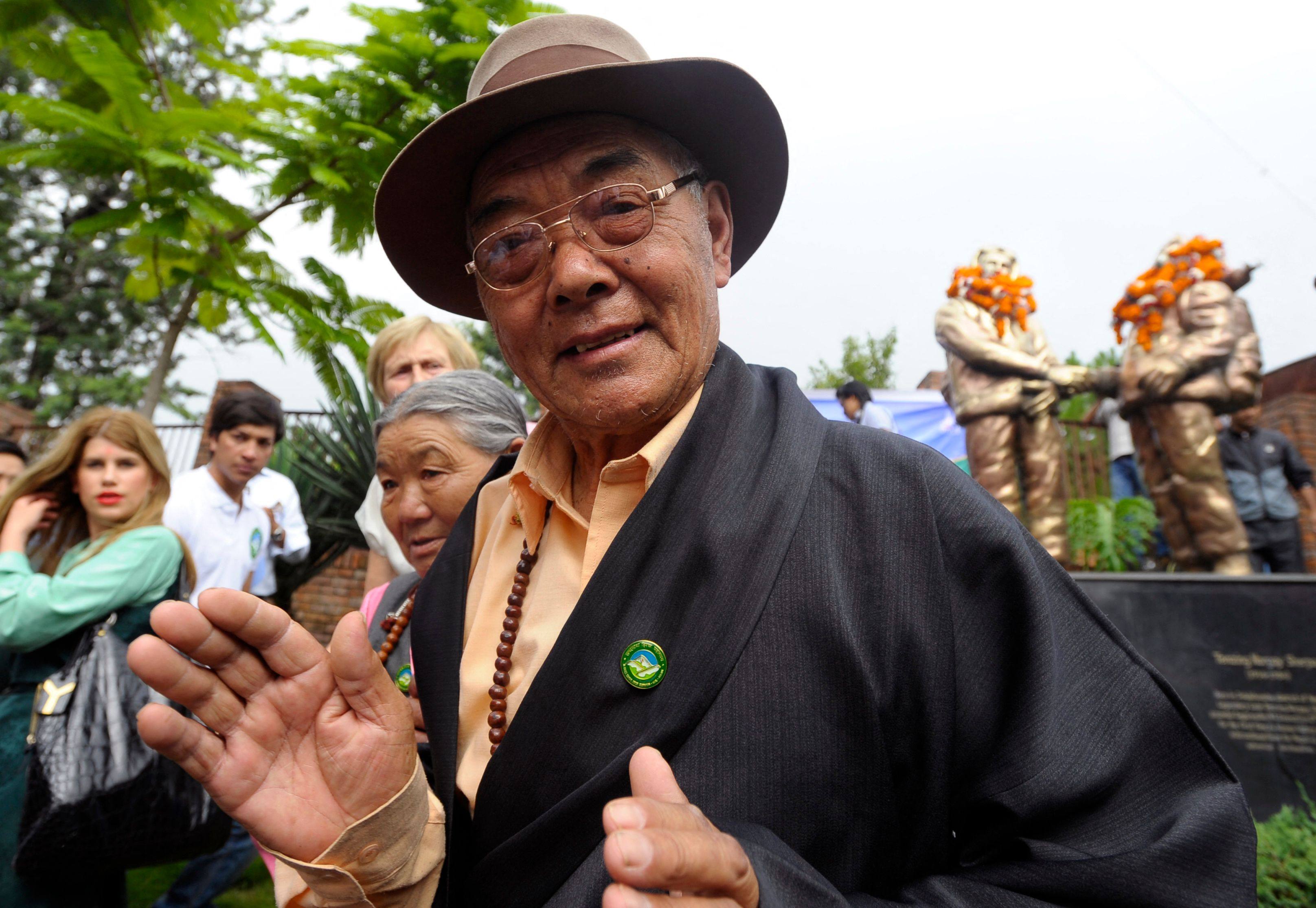 Kanchha Sherpa, a member of the expedition team that placed Tenzing Norgay and Edmund Hillary on the summit of the world’s highest mountain, gestures during a celebration in Kathmandu in 2013. Photo: AFP