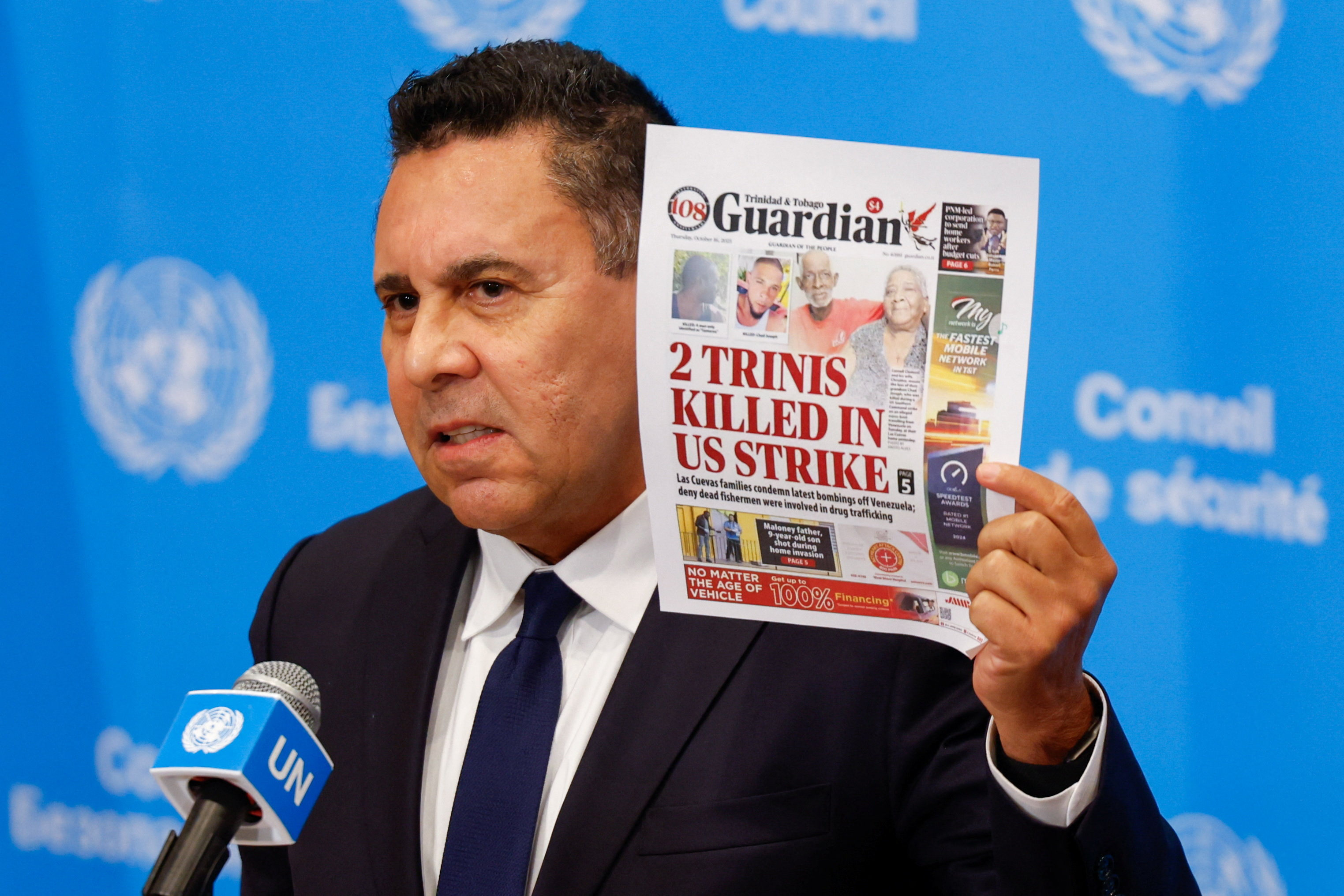 Venezuela’s UN ambassador Samuel Moncada holds up the cover story of local Trinidadian newspaper Guardian on the deaths. Photo: Reuters