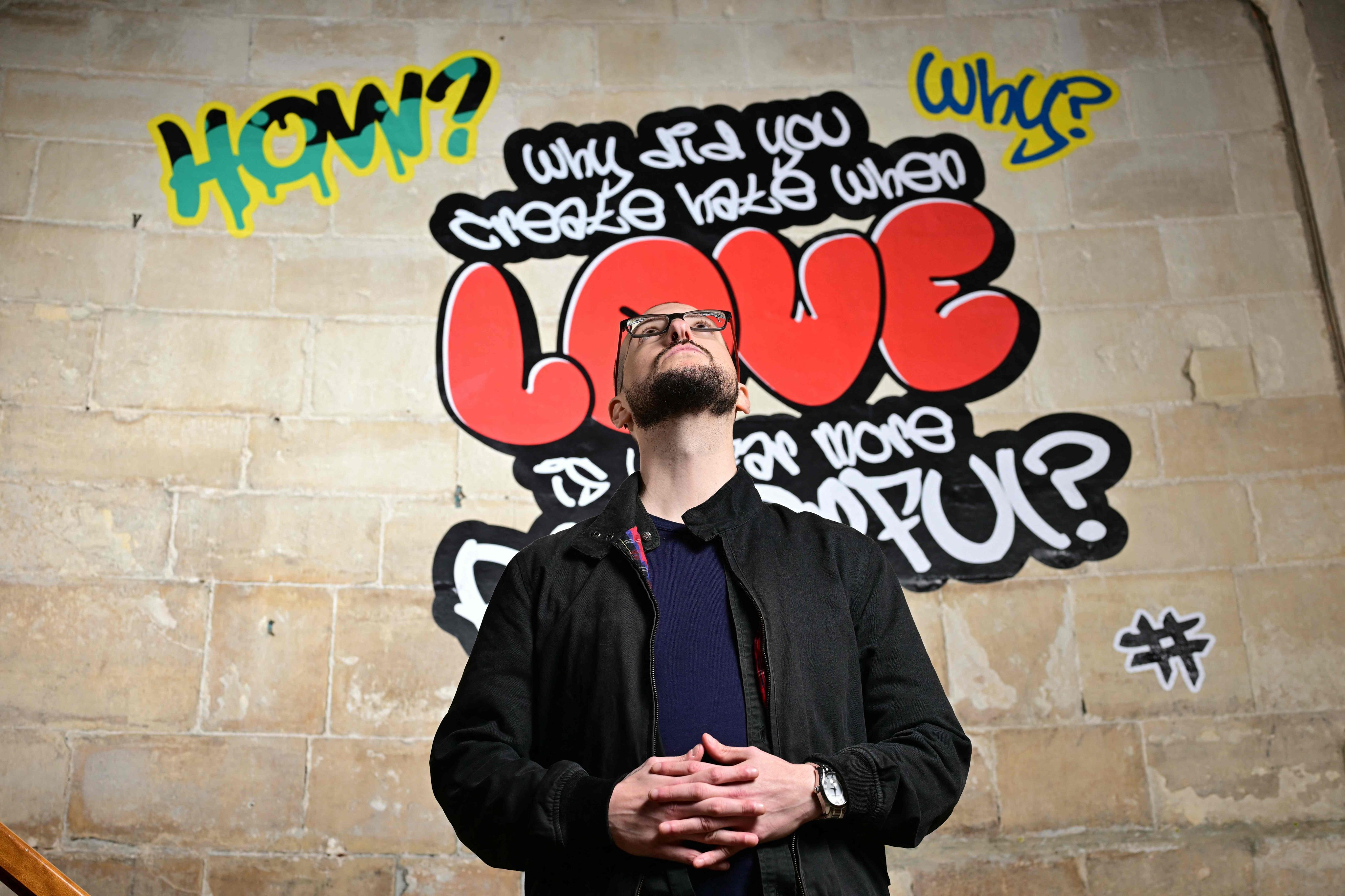 Poet Alex Vellis poses inside Canterbury Cathedral in Canterbury, southeast England, on October 16, 2025, where graffiti-style artworks are currently being displayed as part of an exhibition. Photo: AFP