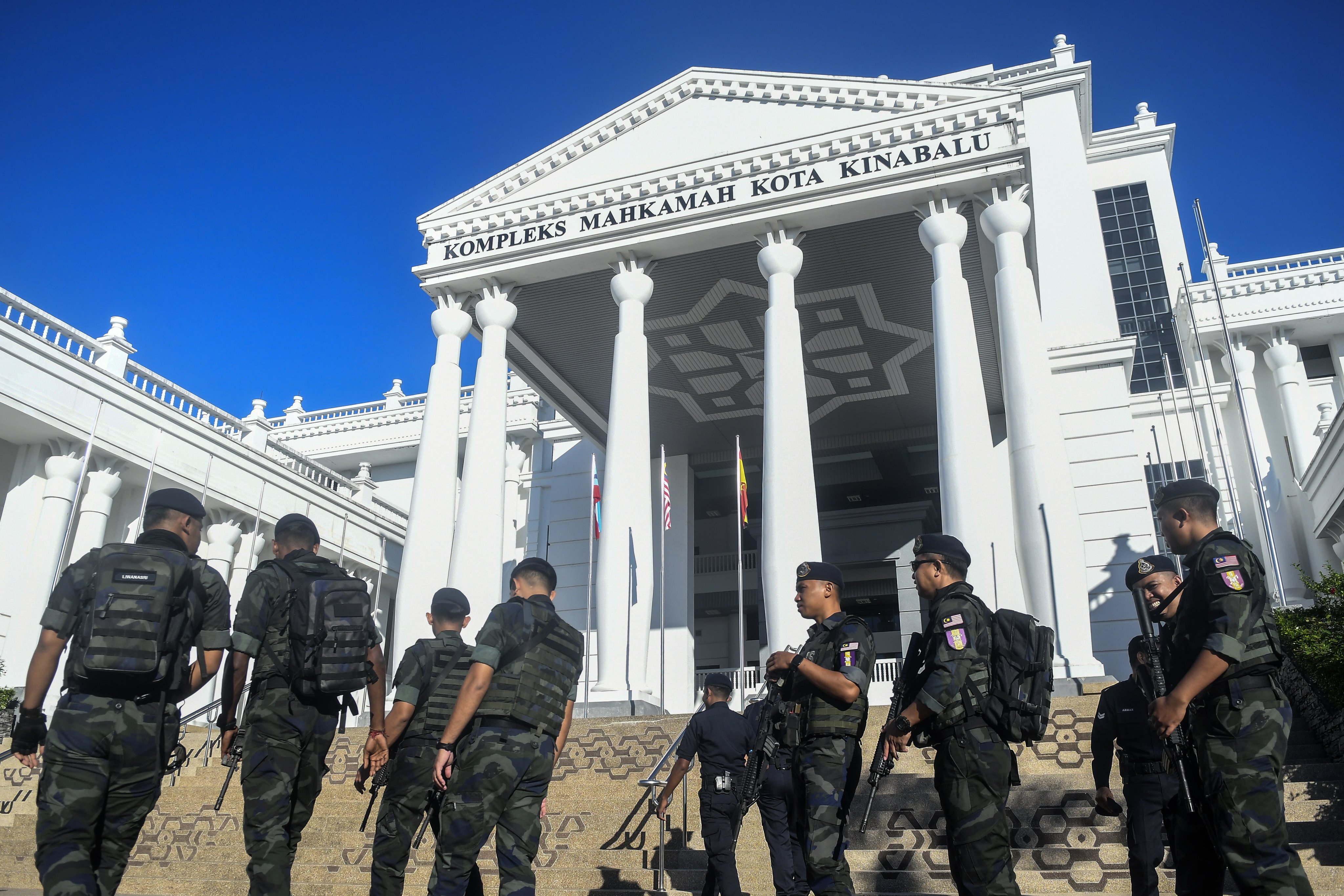 Officers from the Royal Malaysian Police guard outside the Kota Kinabalu Court Complex, where the inquest of student Zara Qairina’s death in Kota Kinabalu, Sabah, was held on September 4. Photo: EPA