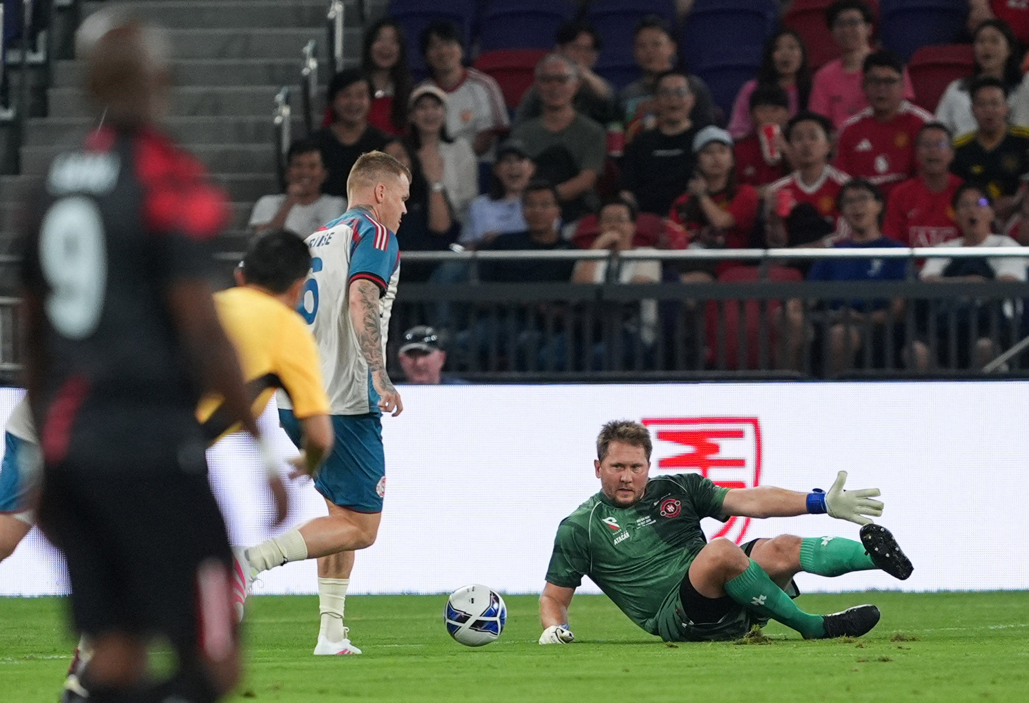 Goalkeeper Tomasz Kuszczak injured his knee as he fell and gave away an early goal to John Arne Riise (left). Photo: Eugene Lee
