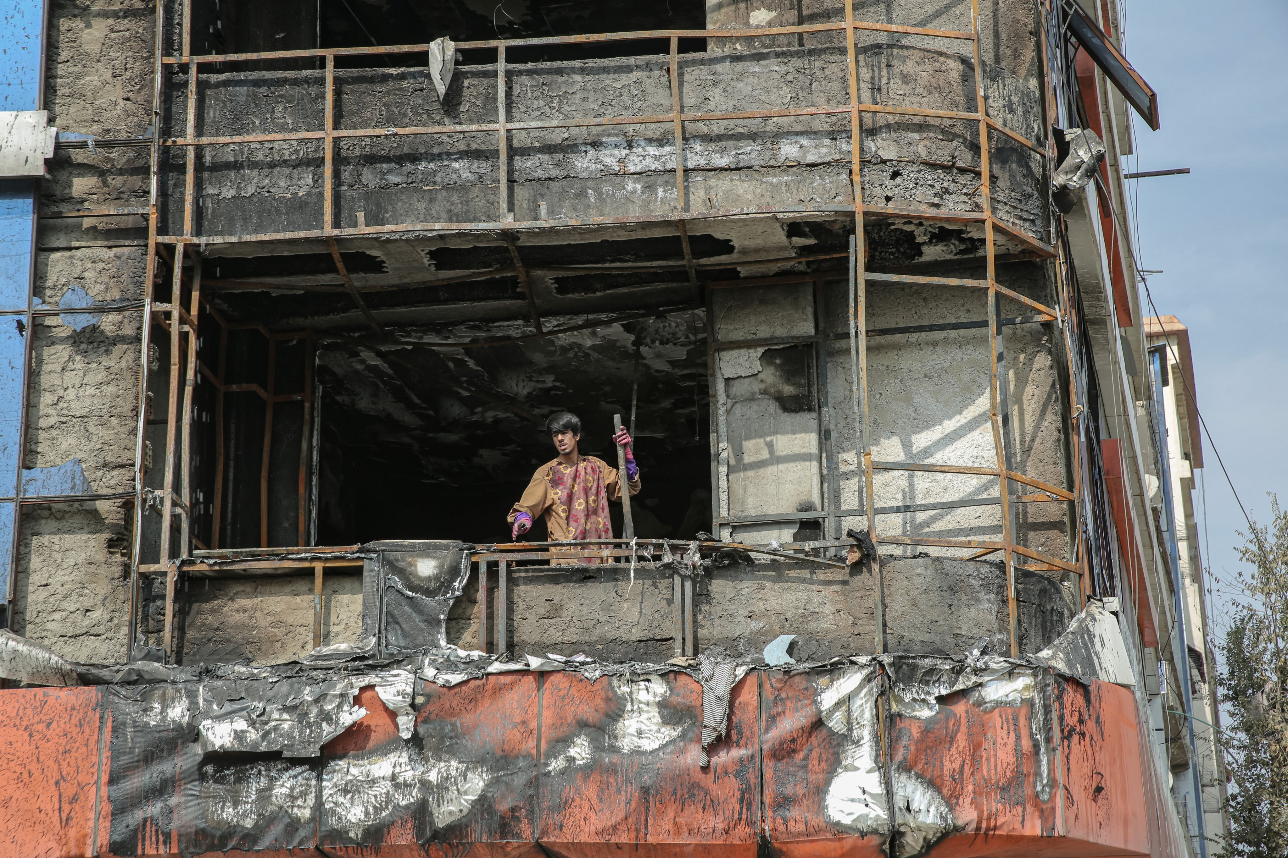 Men look out from a damaged building hit during an alleged Pakistani strike in Kabul, Afghanistan, on Sunday. Photo: EPA-EFE