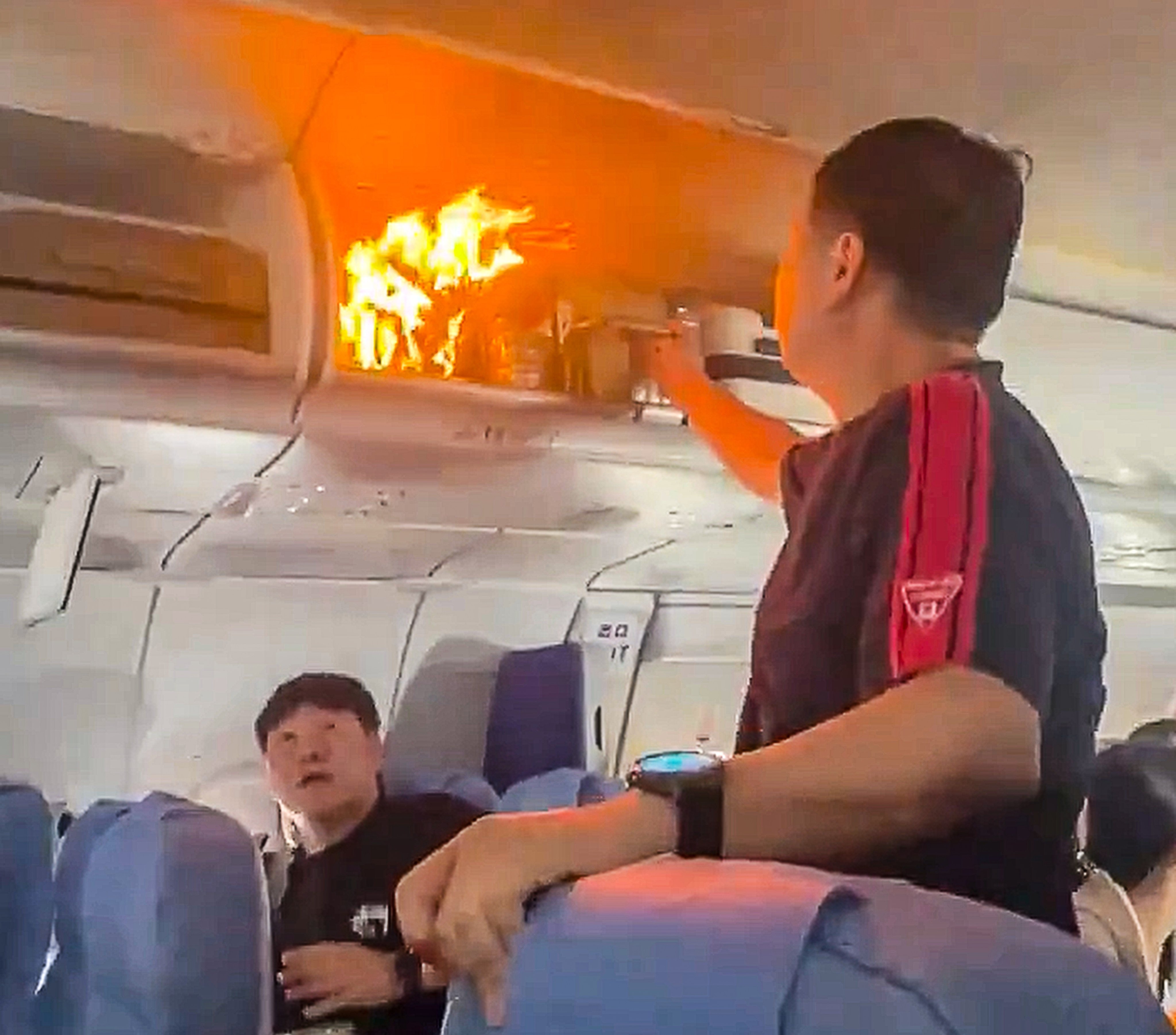 A video clip circulating online showed travellers and crew trying to put out a fire in an overhead compartment. Photo: Handout