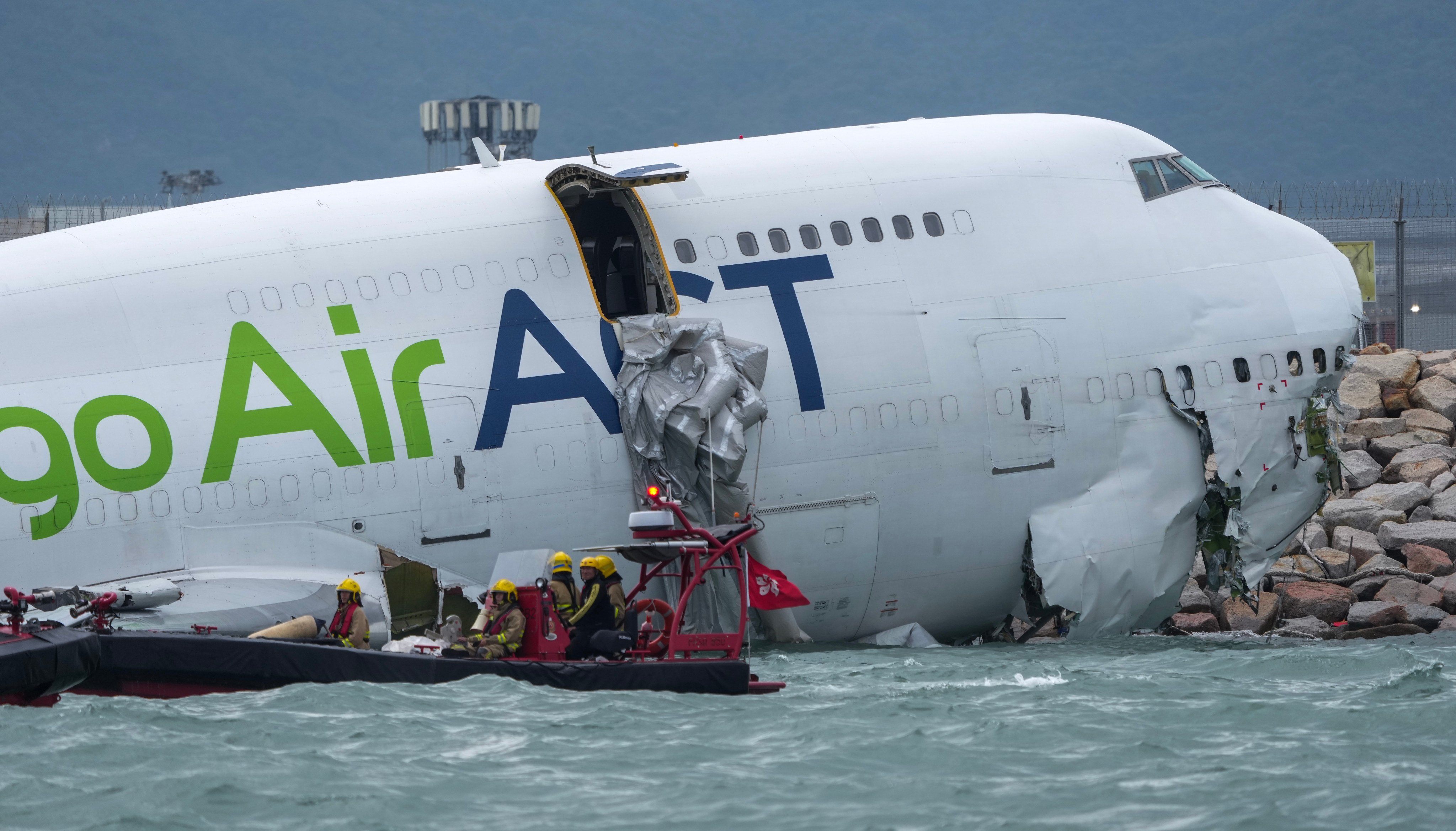 Two people were killed after the cargo plane skidded off the north runway of Hong Kong International Airport striking a ground vehicle and plunging almost entirely into the sea. Photo: Sam Tsang