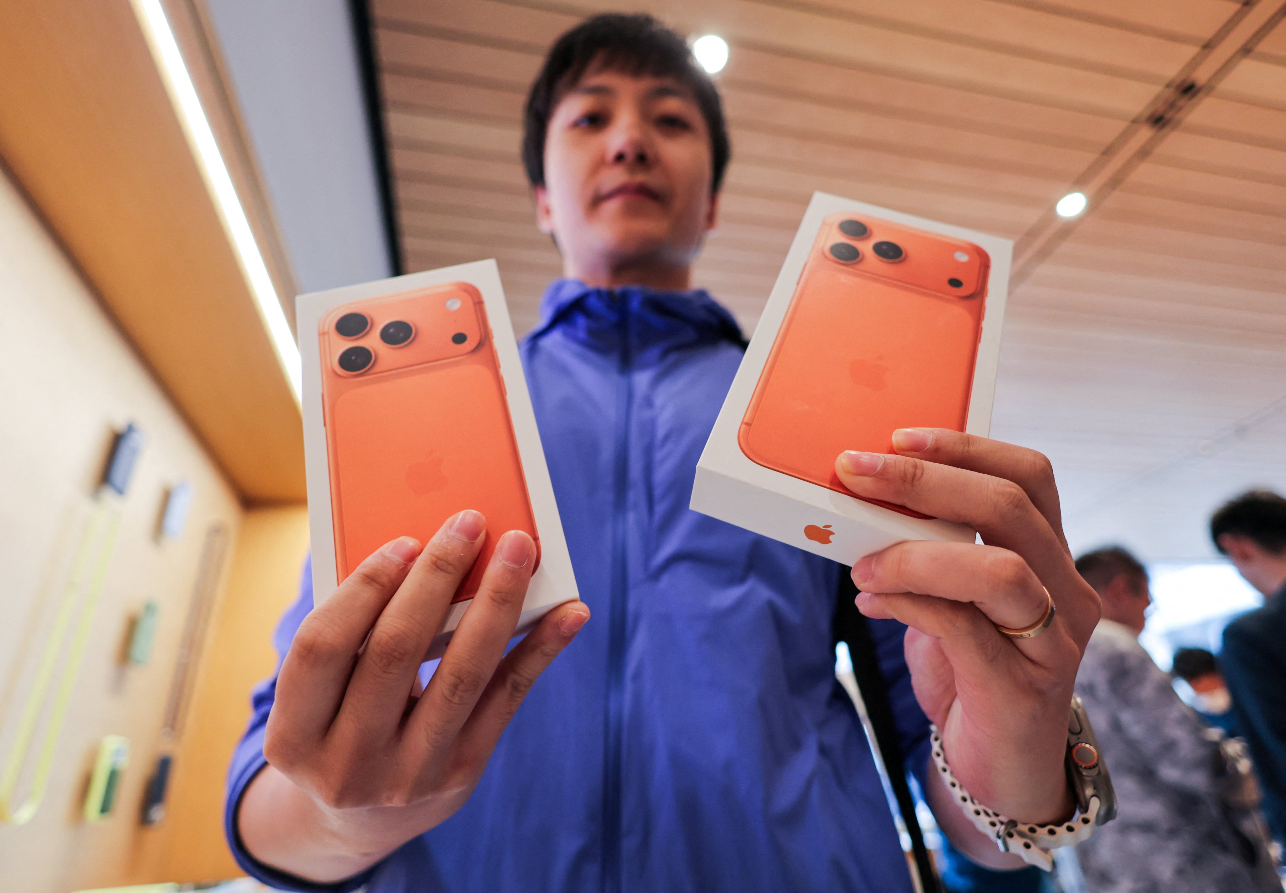 A man shows boxes with newly bought iPhone 17 handsets inside the Apple Store in Beijing’s Sanlitun area. Photo: Reuters