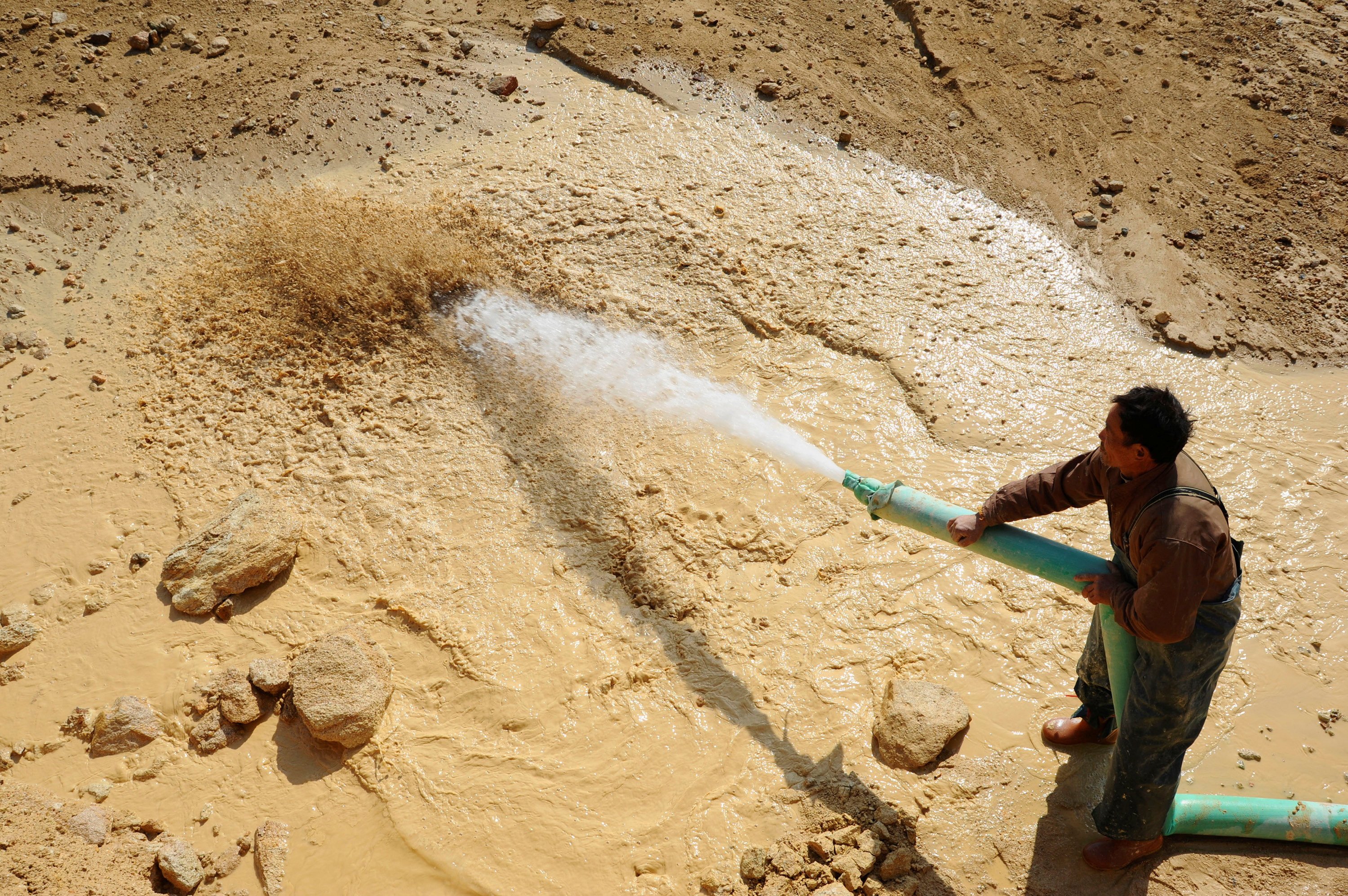 A worker waters the site of a rare earth mine in China’s eastern Jiangxi province. China’s exports of rare earth magnets to the United States have plunged amid the trade war. Photo: Reuters