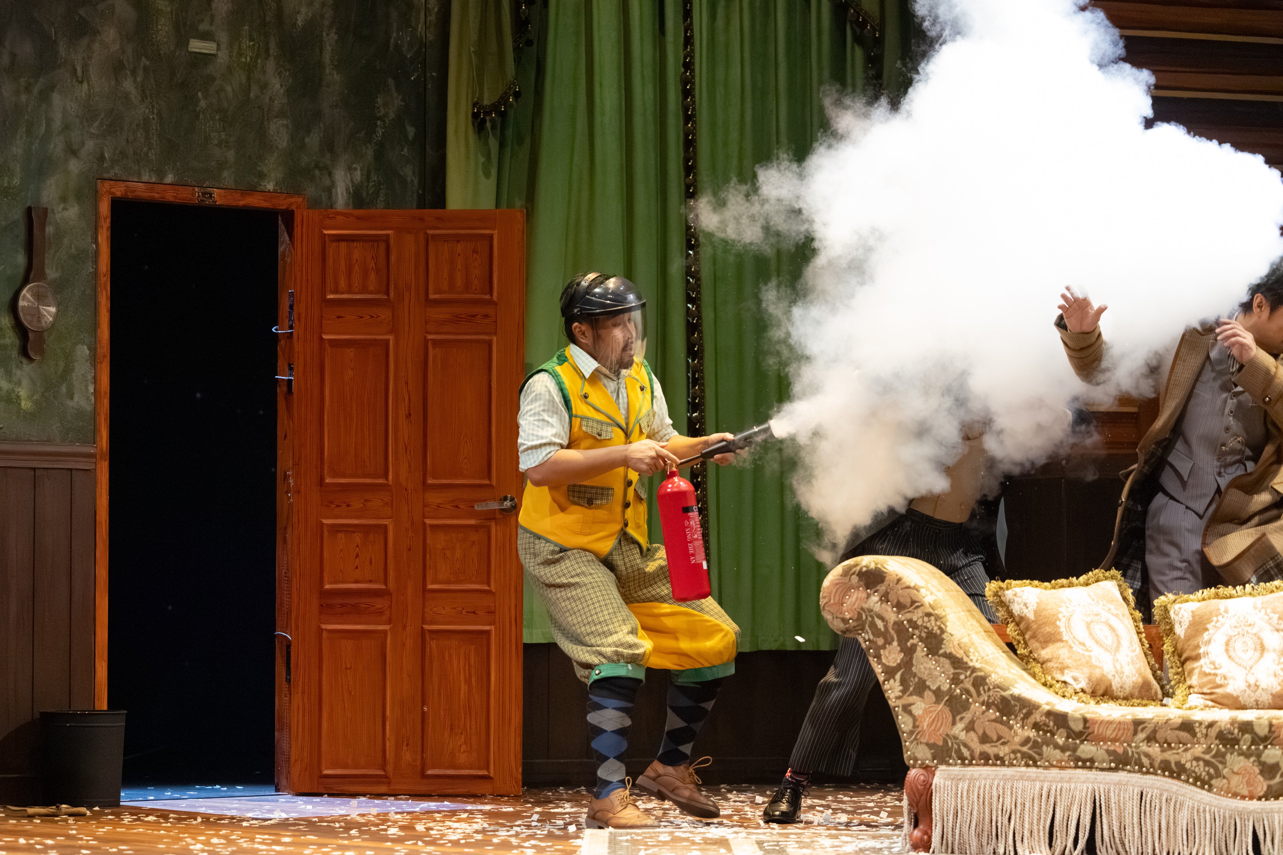 Michael Mok lets off a fire extinguisher in a scene from The Play That Goes Wrong, a Cantonese adaptation of the West End and Broadway hit that won best new comedy at the 2015 Laurence Olivier Awards, at the Kwai Tsing Theatre in Hong Kong on October 18, 2025. Photo: Chung Ying Theatre