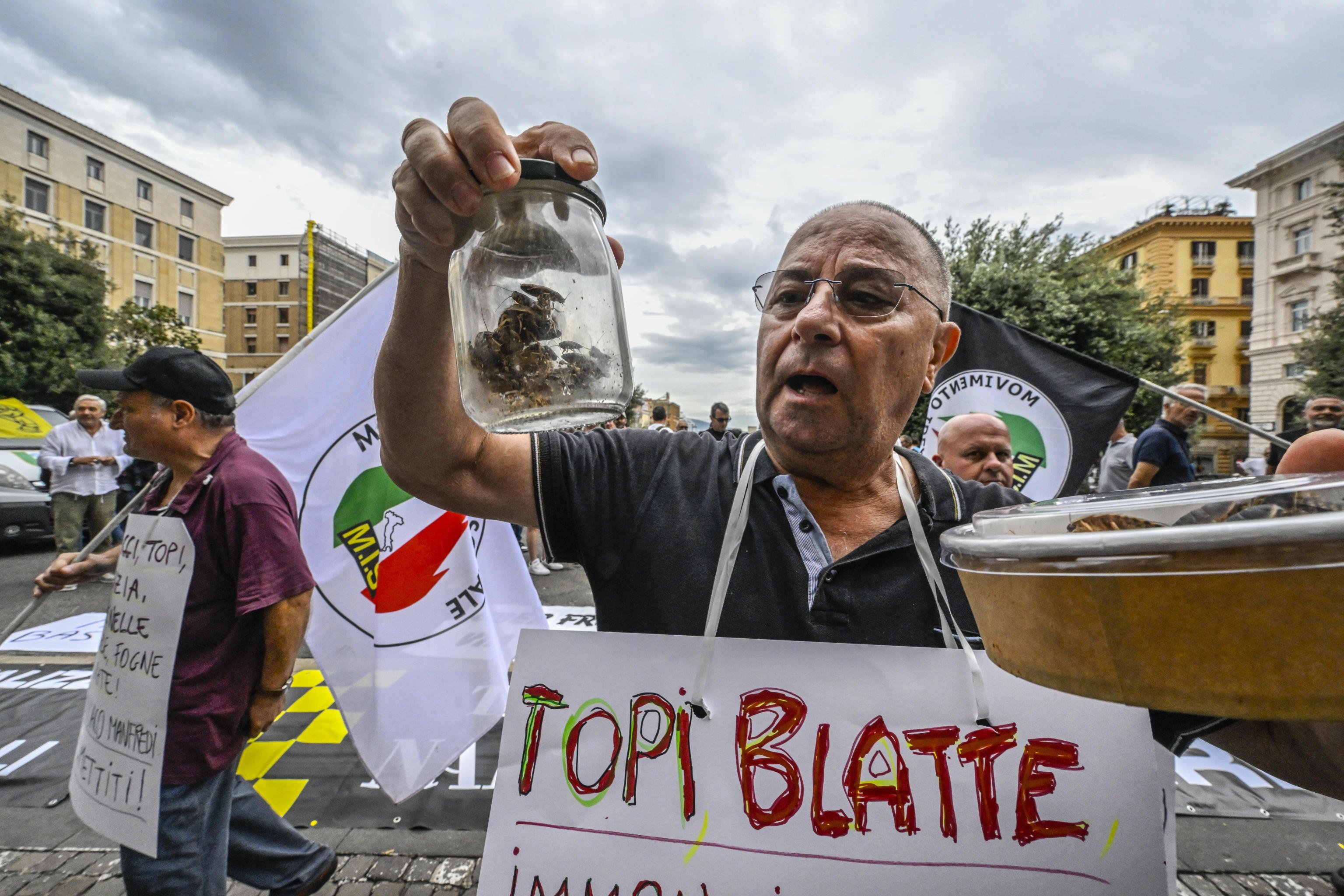 Raffaele Bruno, national secretary of the Movimento Idea Sociale, holds a jar containing live cockroaches during a protest in front of the City Hall in Naples, southern Italy, on September 24. Photo: EPA