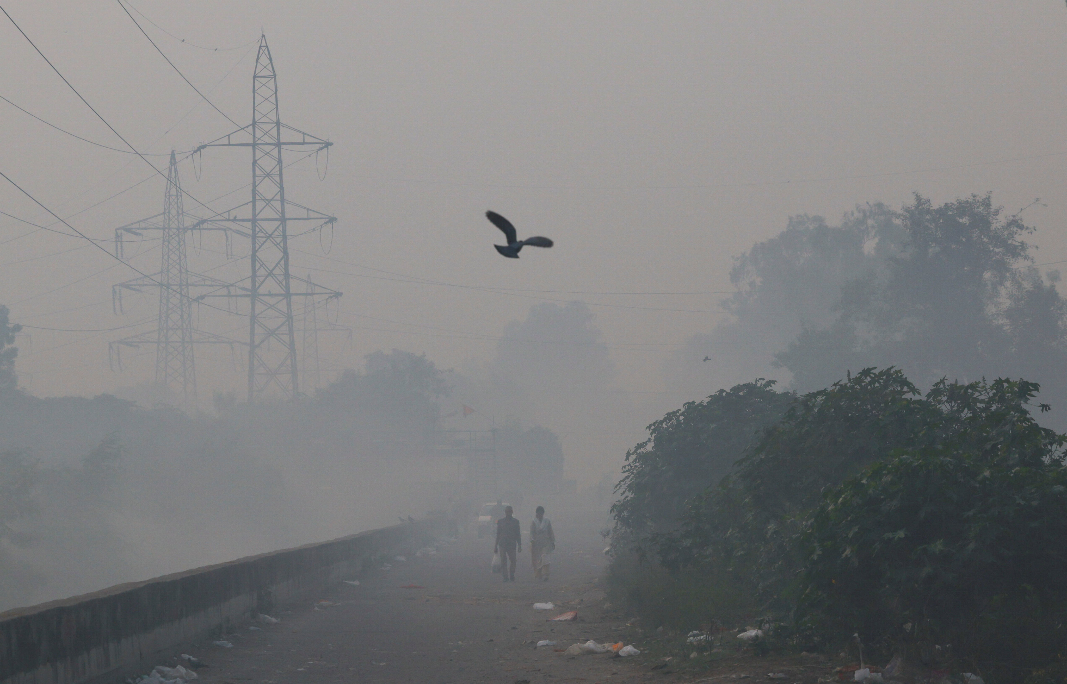 People walk through smog in New Delhi, India, on Monday morning. Photo: Reuters