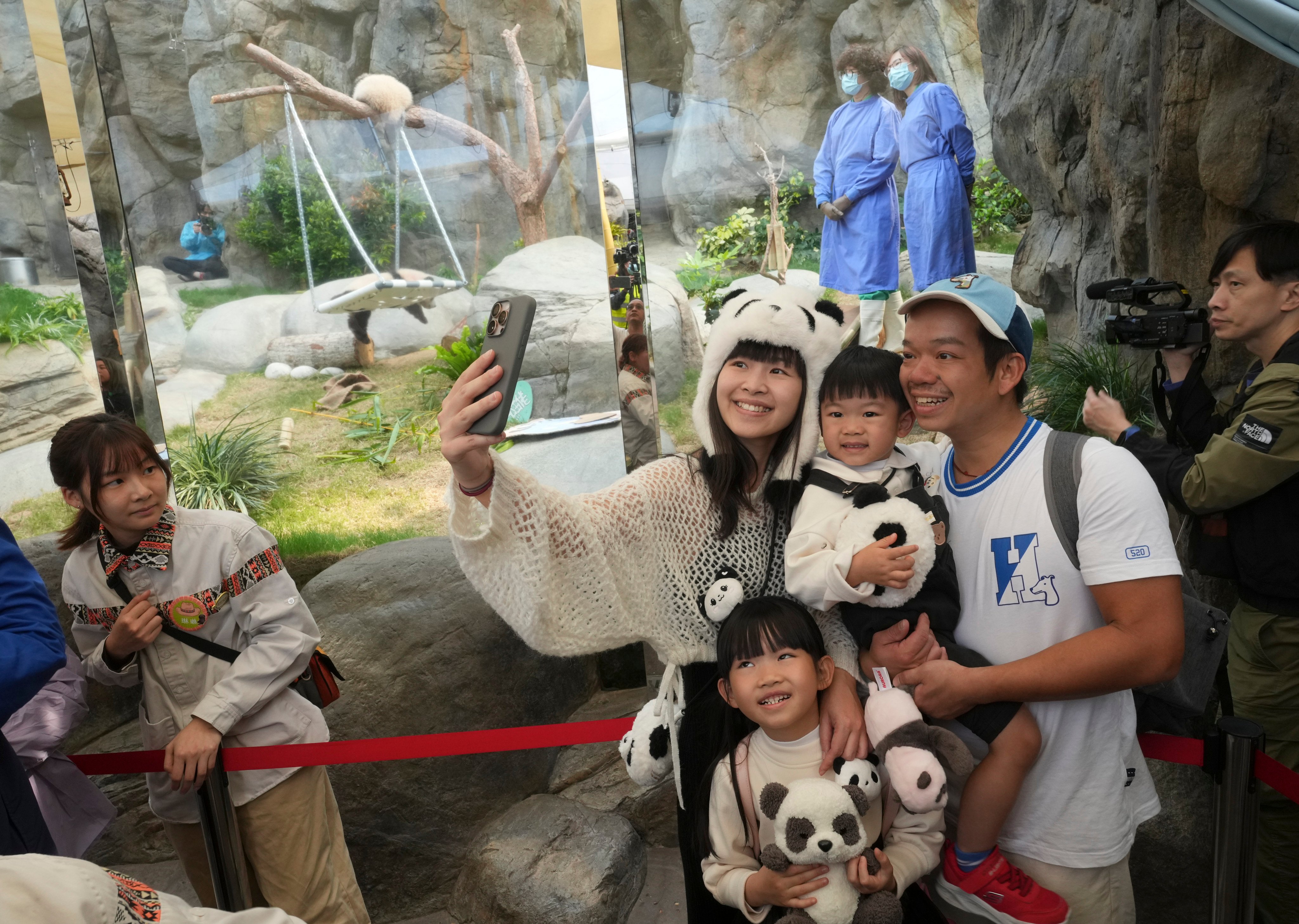 A family decked out in panda merchandise poses for a picture at Ocean Park. Photo: Sam Tsang