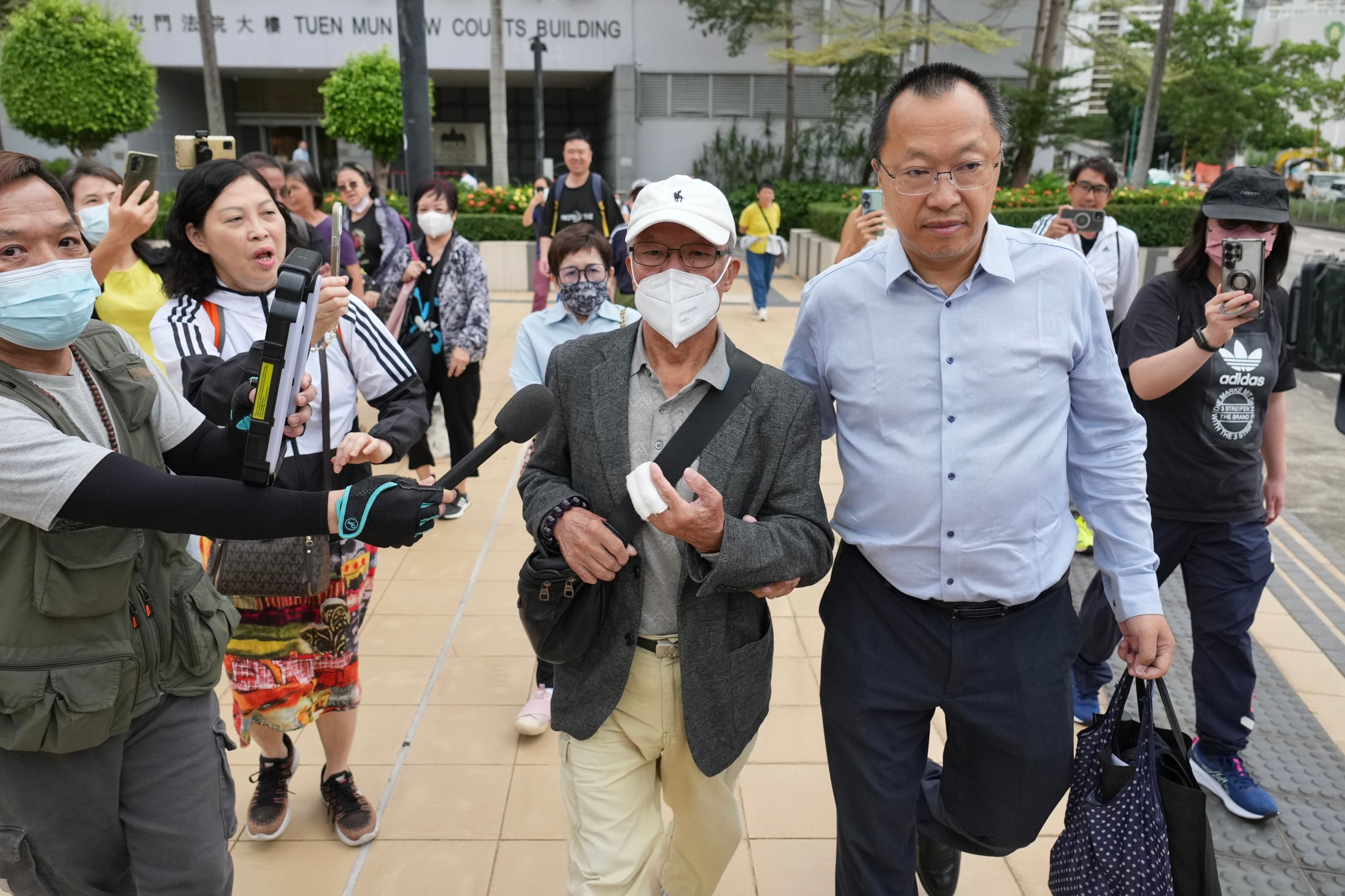 Ho Huen (centre), 77, known on the Internet as “Mr Ho”, leaves Tuen Mun Court on Tuesday after being given a suspended jail sentence. Photo: Karma Lo