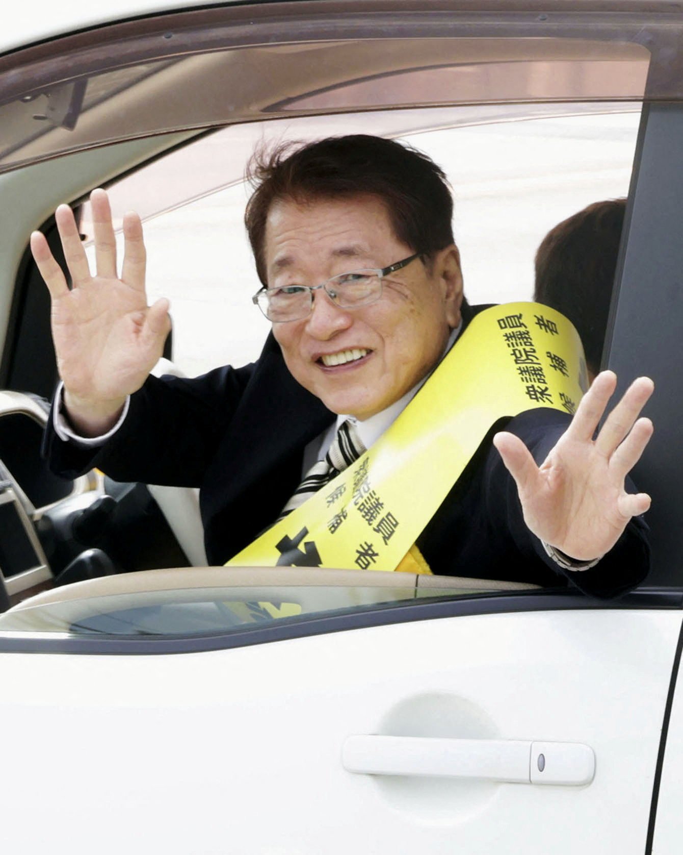 Taku Yamamoto, the husband of Japan’s new Prime Minister Sanae Takaichi and a former member of the LDP, waves from a car during a campaign in Sabae, Fukui Prefecture, earlier this month. Photo: Kyodo/Reuters