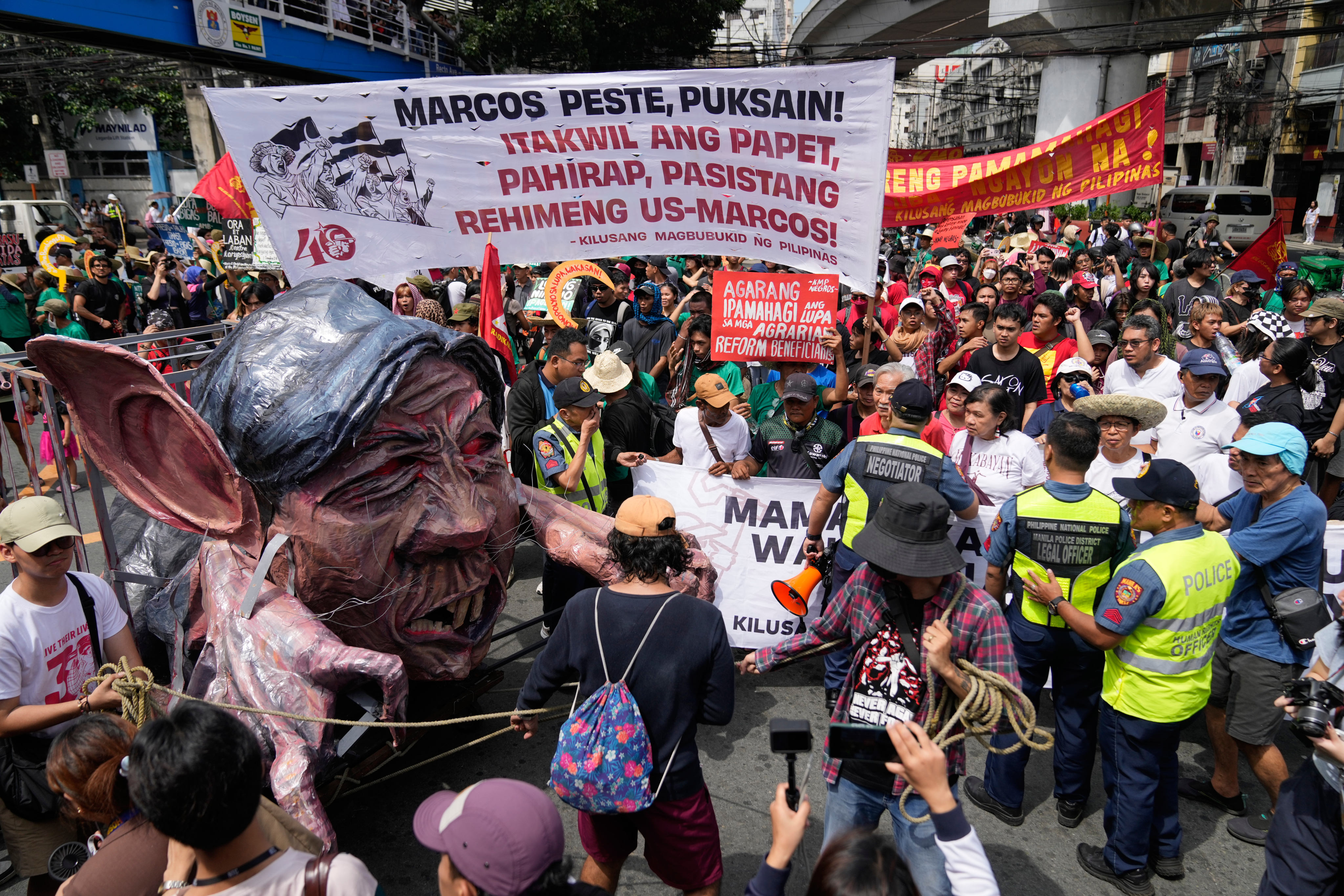 An effigy of Philippine President Ferdinand Marcos Jnr is pushed to the front of the crowd during a farmer-led anti-corruption rally on Tuesday near the Malacanang presidential palace in Manila, the Philippines. Photo: AP