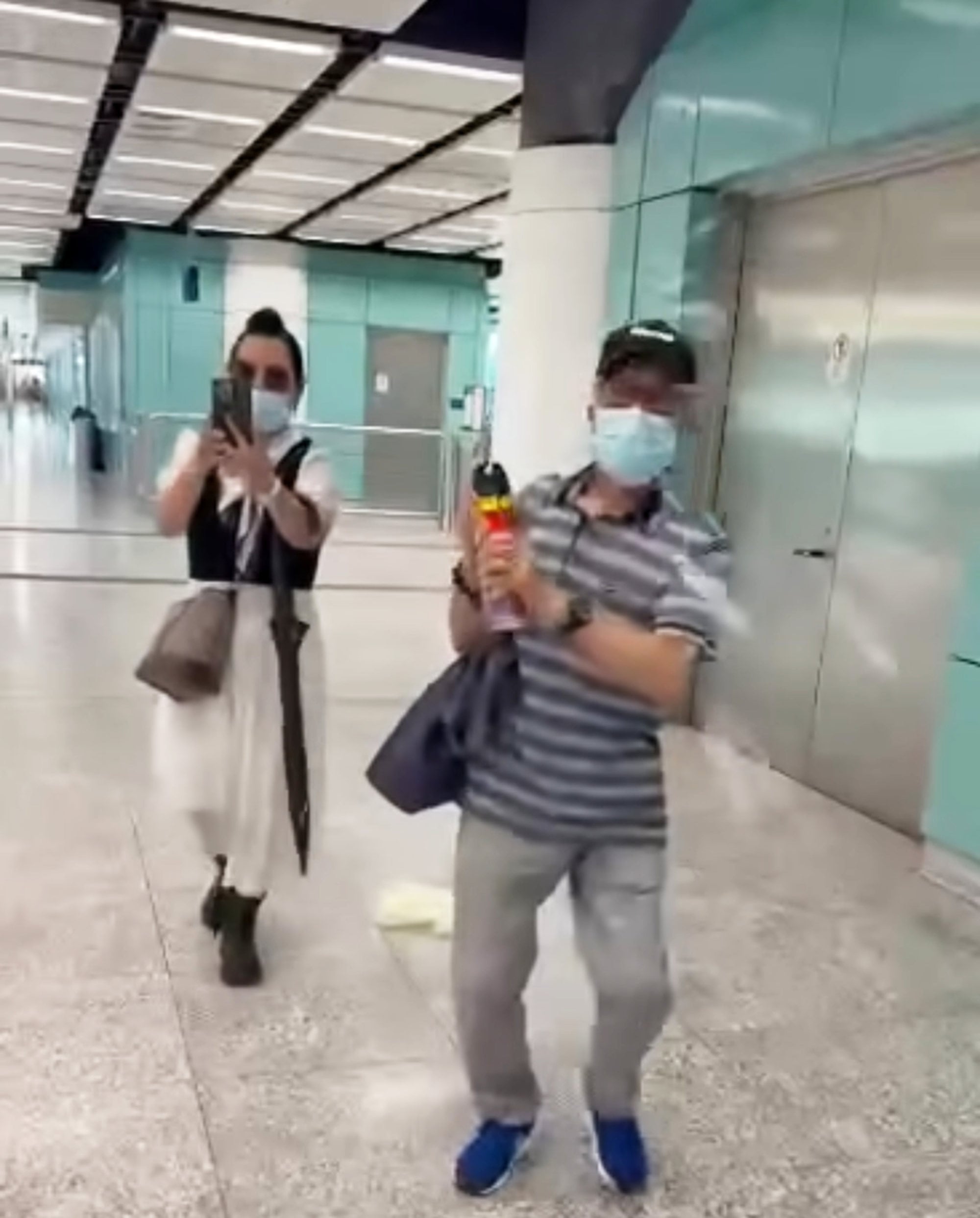 Mr Ho sprays insecticide on a passer-by who levelled taunts at him at Siu Hong railway station. Photo: Handout