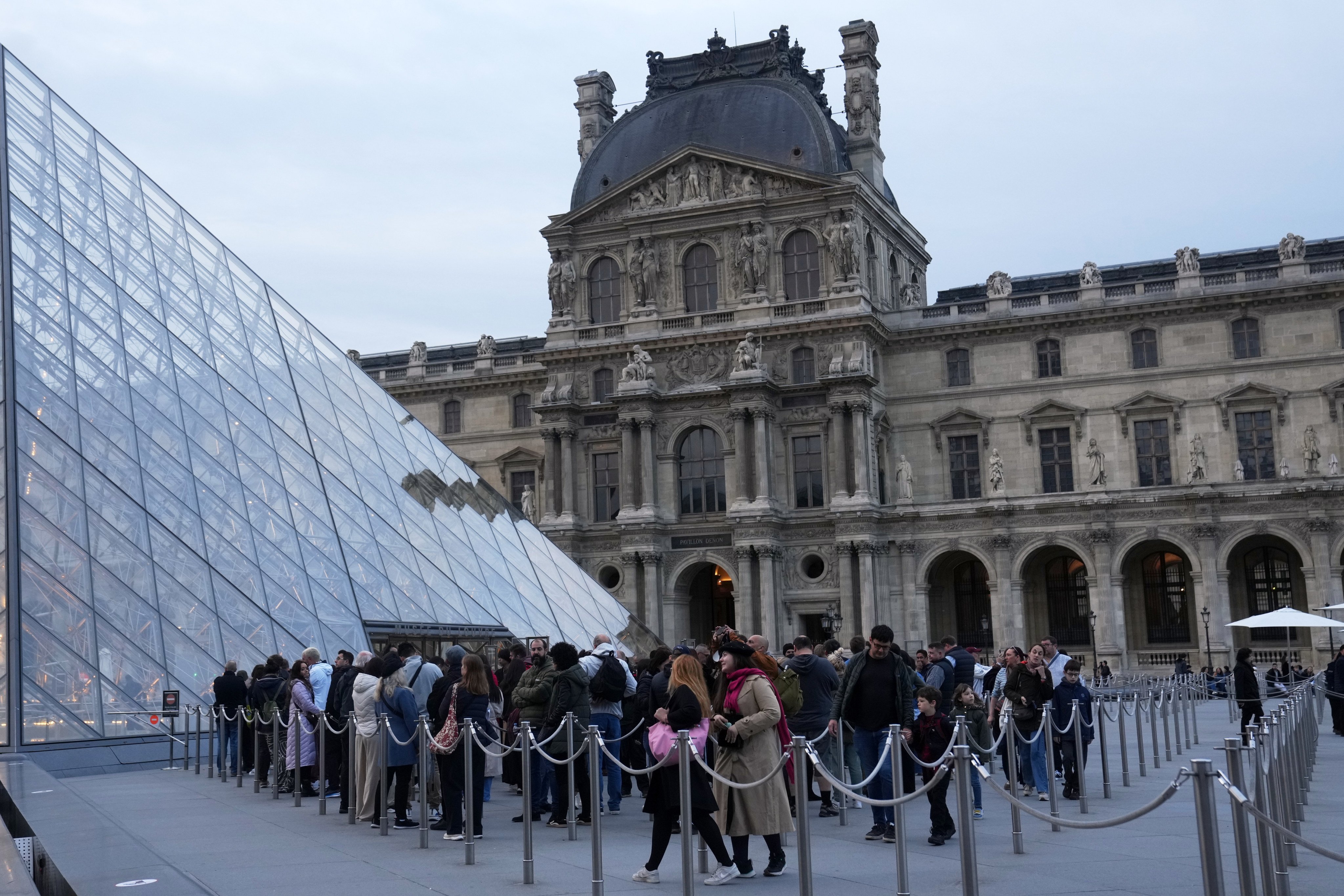 Visitors queue to enter the Louvre, three days after historic jewels were stolen in a daring heist. Photo: AP