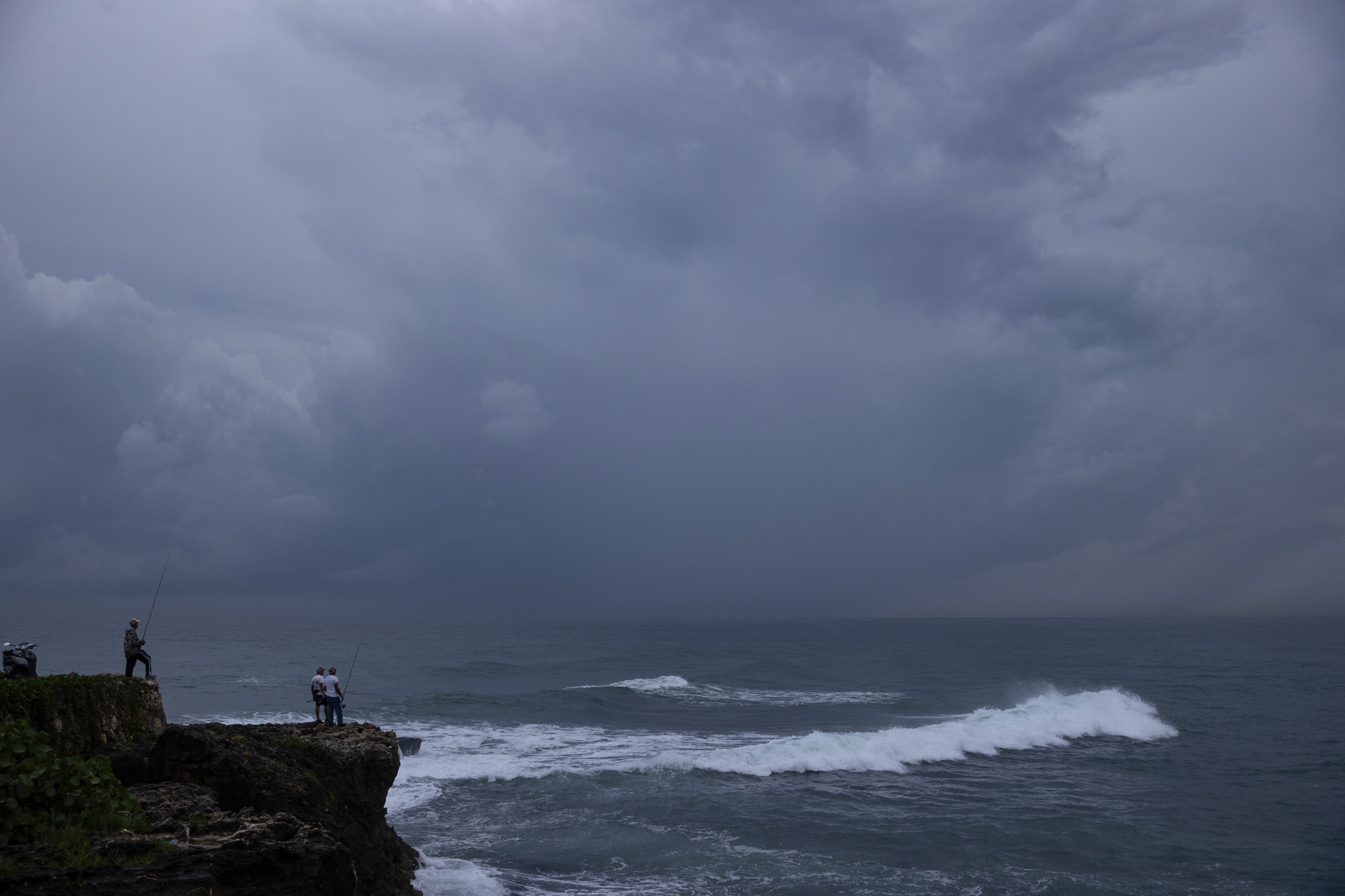 A man fishes on the waterfront in Santo Domingo on Wednesday as the Dominican Republic remains on alert for Tropical Storm Melissa. Photo: EPA