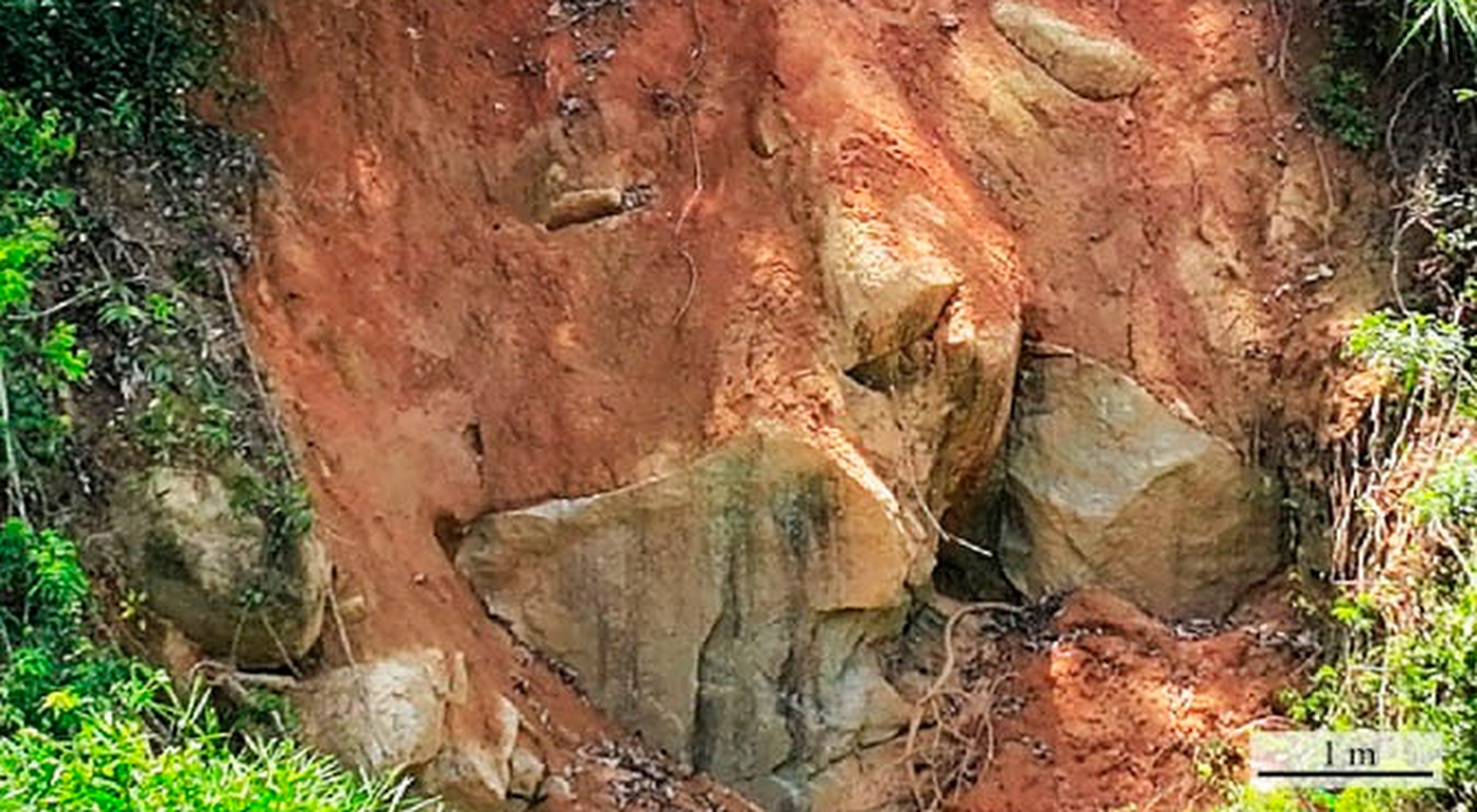 A geological section at the southern rim of the Jilin crater shows a mix of red granite weathered soil and granite fragments. Photo: Handout