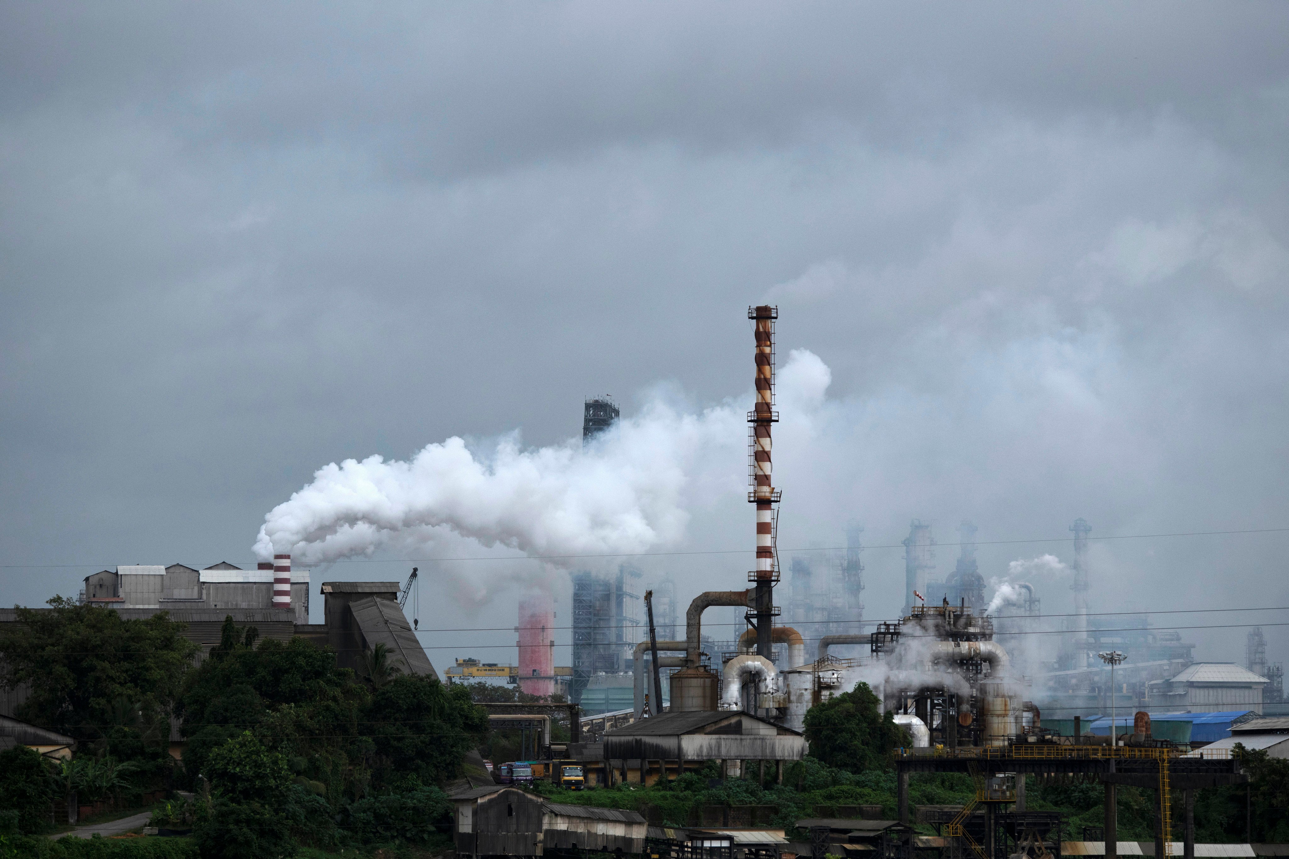 Steam emits from a crude oil refinery in Kochi, Kerala state, India. Photo: AP