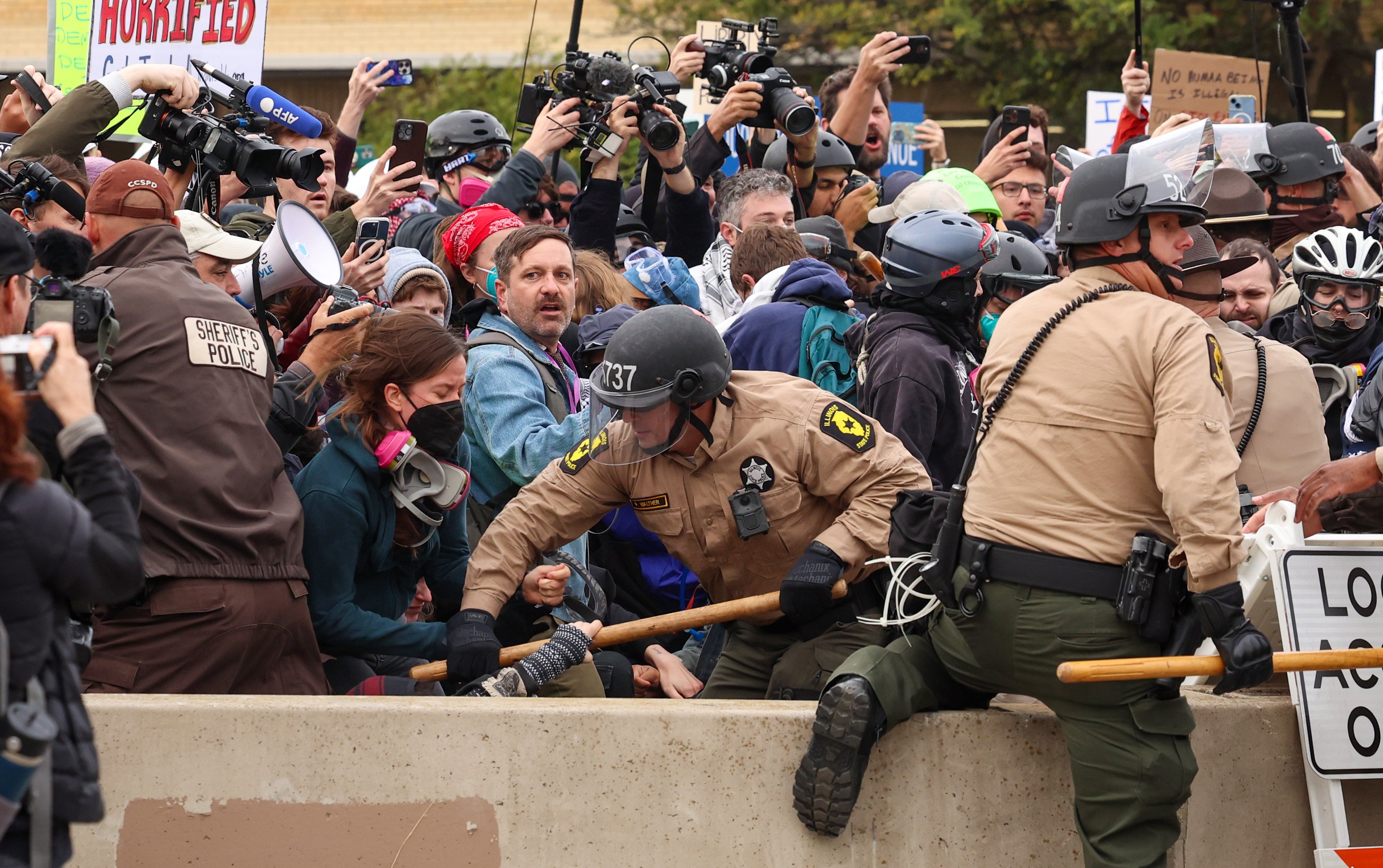 Members of the Illinois state police and Cook County sheriff’s office tussle with protesters near the US Immigration and Customs Enforcement holding facility in Broadview, Illinois, on October 10. Photo: TNS