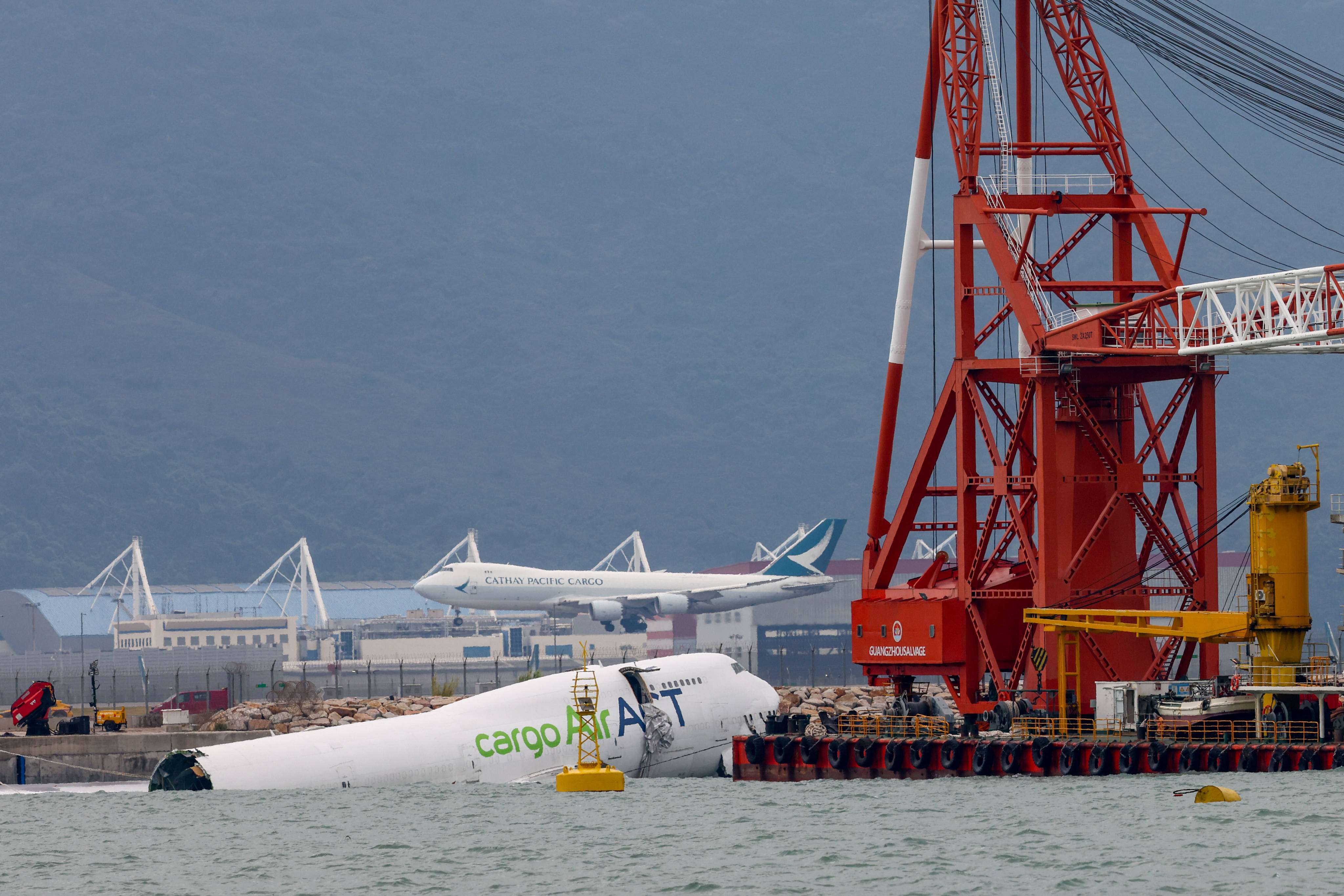 Securing and removing the cargo plane that crashed after veering off its path at Hong Kong’s airport and killing two security workers will take at least two days, experts say. Photo: Dickson Lee