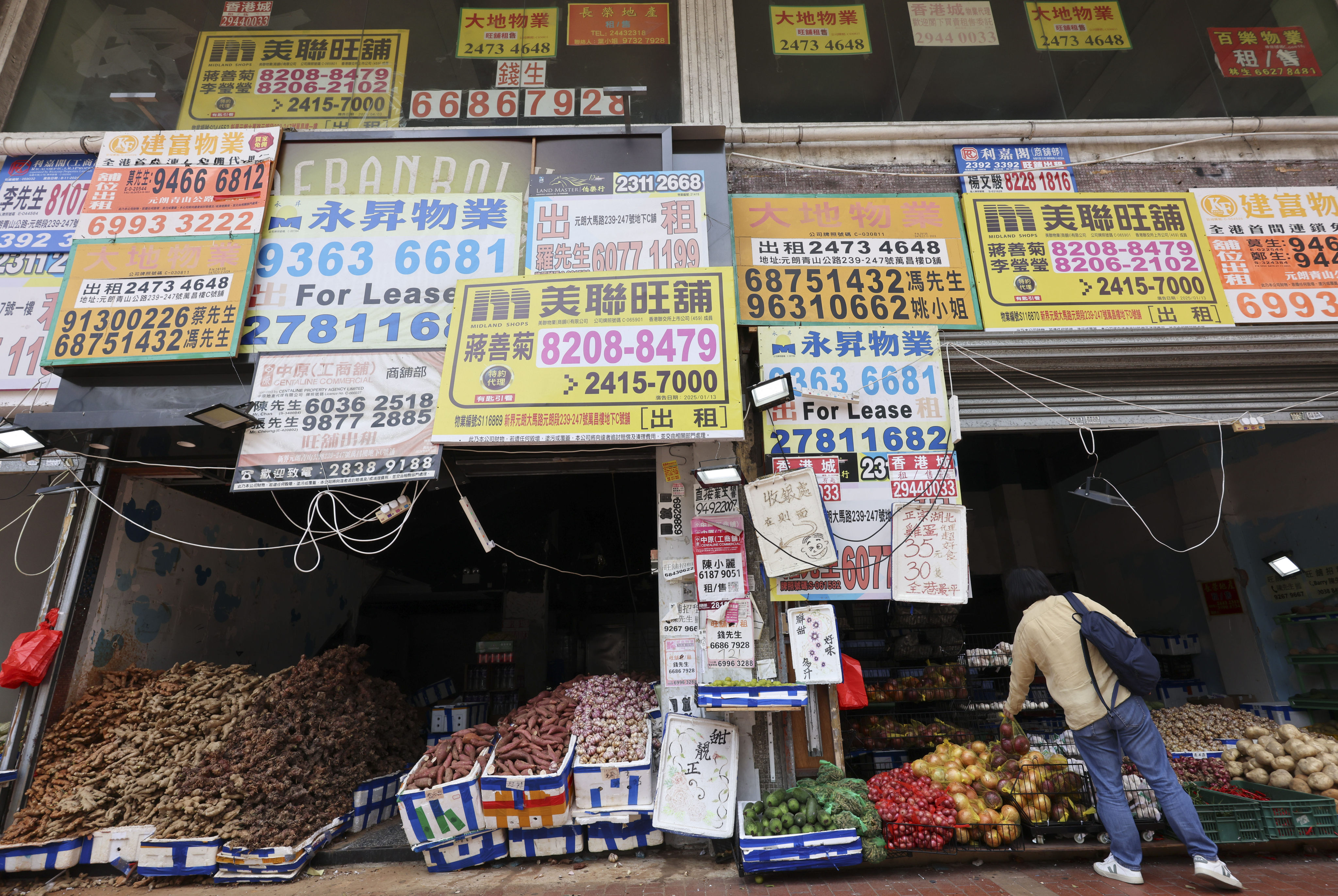 Leasing advertisements compete for attention along a row of shops in Yuen Long on July 2. Photo: Jelly Tse