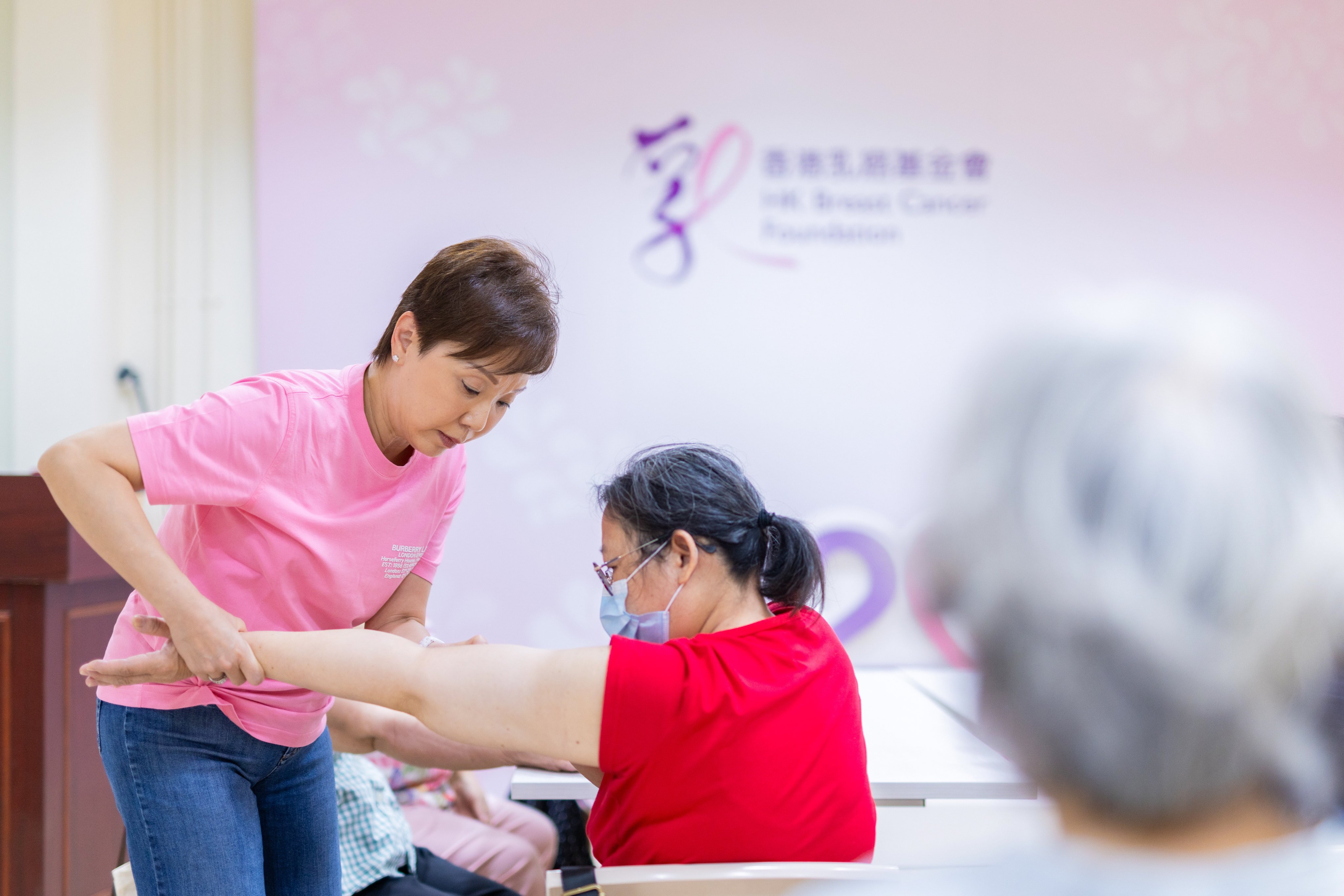 Hui Wai-yee, a three-time breast cancer survivor and volunteer, demonstrates techniques to help with post-surgery recovery. Photo: Handout