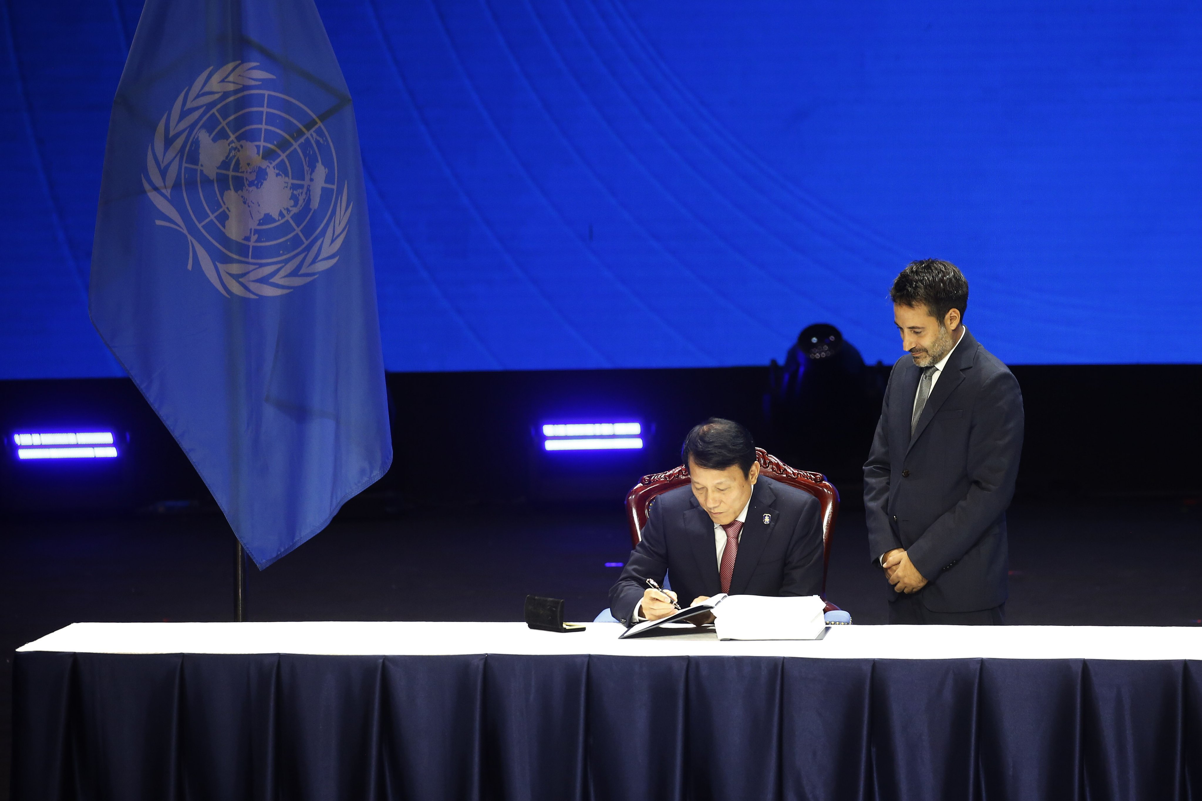 Vietnamese Minister of Public Security Luong Tam Quang signs a document during the signing ceremony of the UN Convention against Cybercrime in Hanoi on Saturday. Photo: EPA