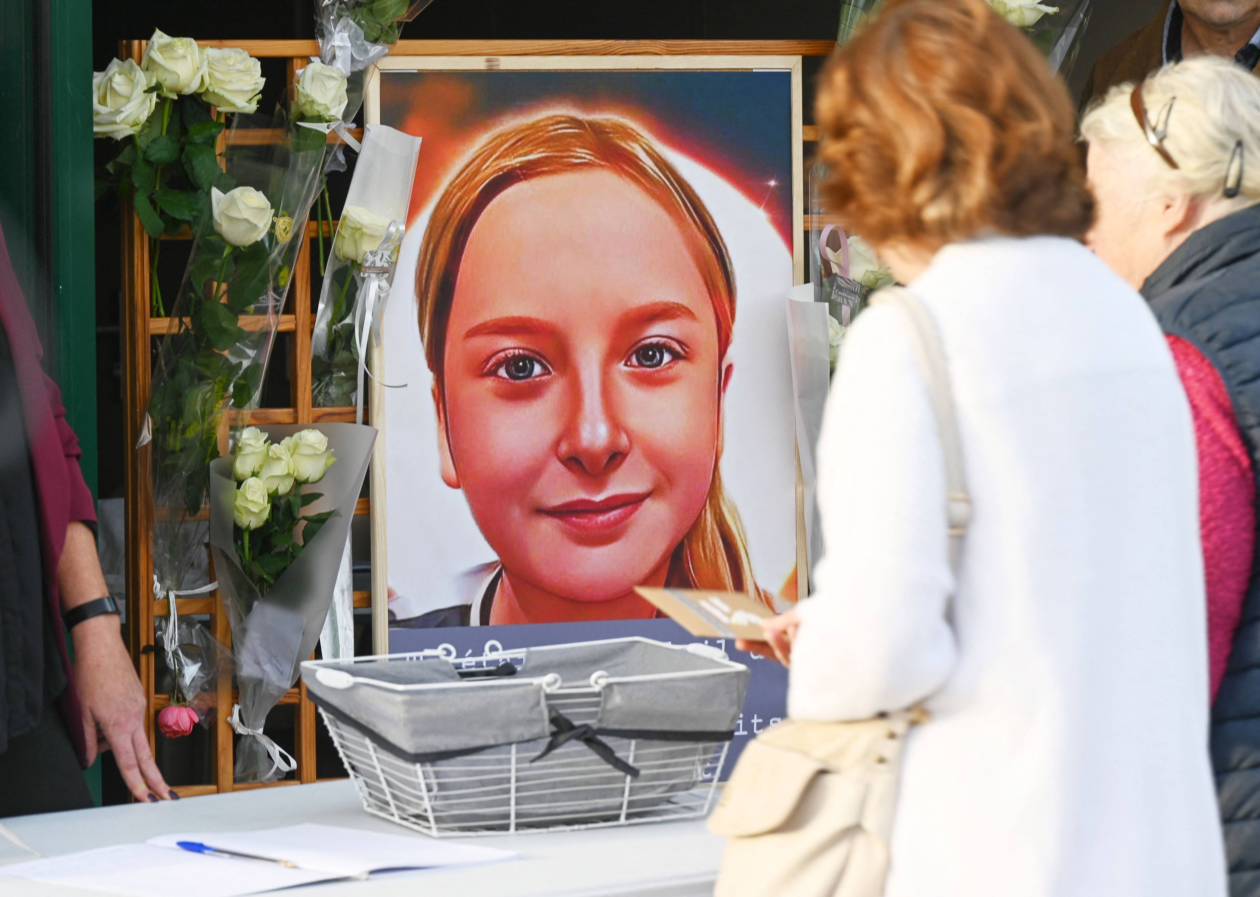 Locals lay notes and flowers near a portrait of Lola Daviet in Fouquereuil, France, in October 2022. Photo: AFP