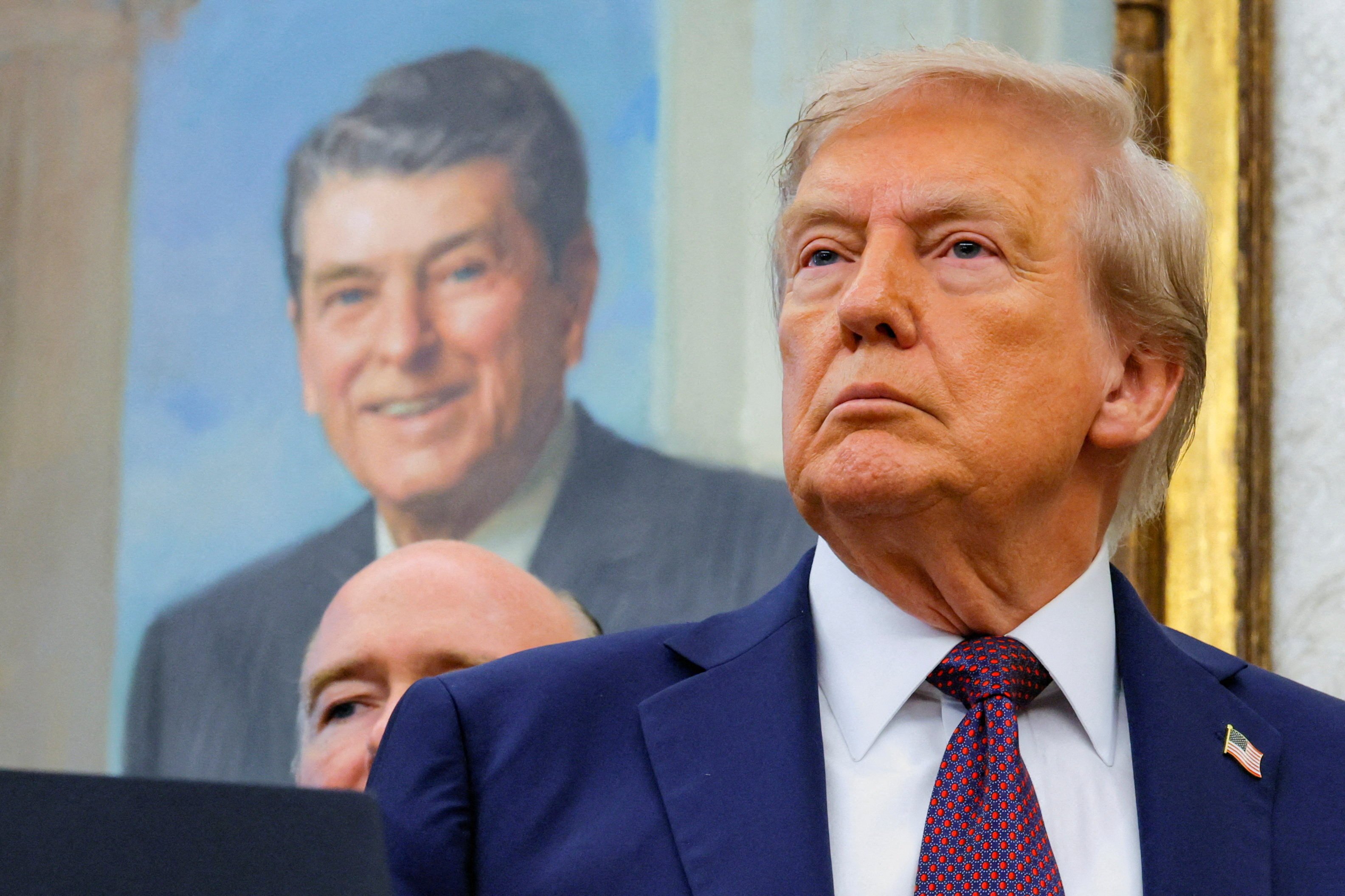 US President Donald Trump stands in front of a painting of former US president Ronald Reagan in the Oval Office in September. Photo: Reuters
