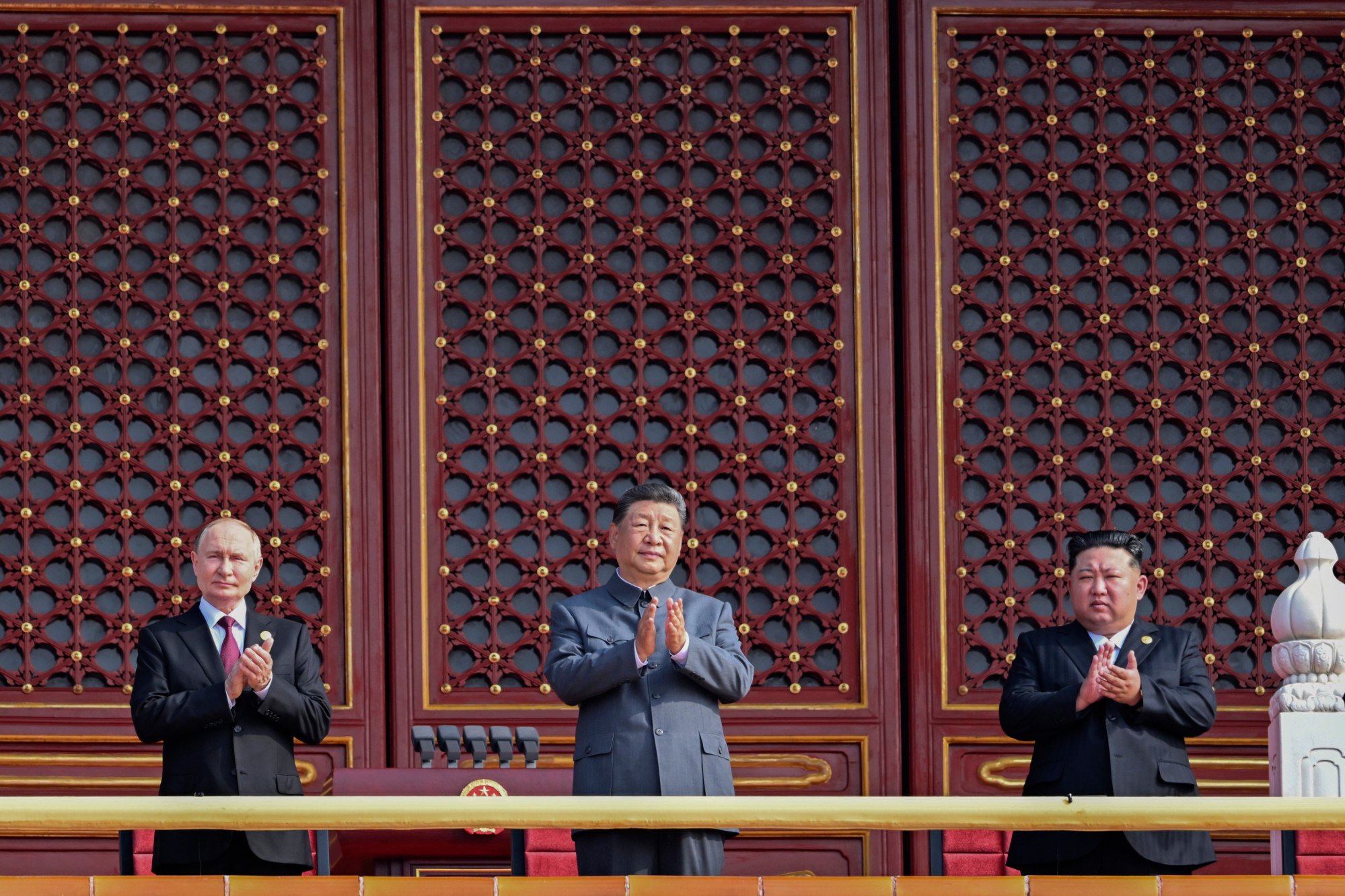 (From left) Russian President Vladimir Putin, Chinese President Xi Jinping and North Korean leader Kim Jong-un applaud from Tiananmen Gate as they attend a military parade marking the 80th anniversary of the end of World War II at Tiananmen Square in Beijing on September 3. Photo: Xinhua via AP (From left) Russian President Vladimir Putin, Chinese President Xi Jinping and North Korean leader Kim Jong-un applaud from Tiananmen Gate as they attend a military parade marking the 80th anniversary of the end of World War II at Tiananmen Square in Beijing on September 3. Photo: Xinhua via AP