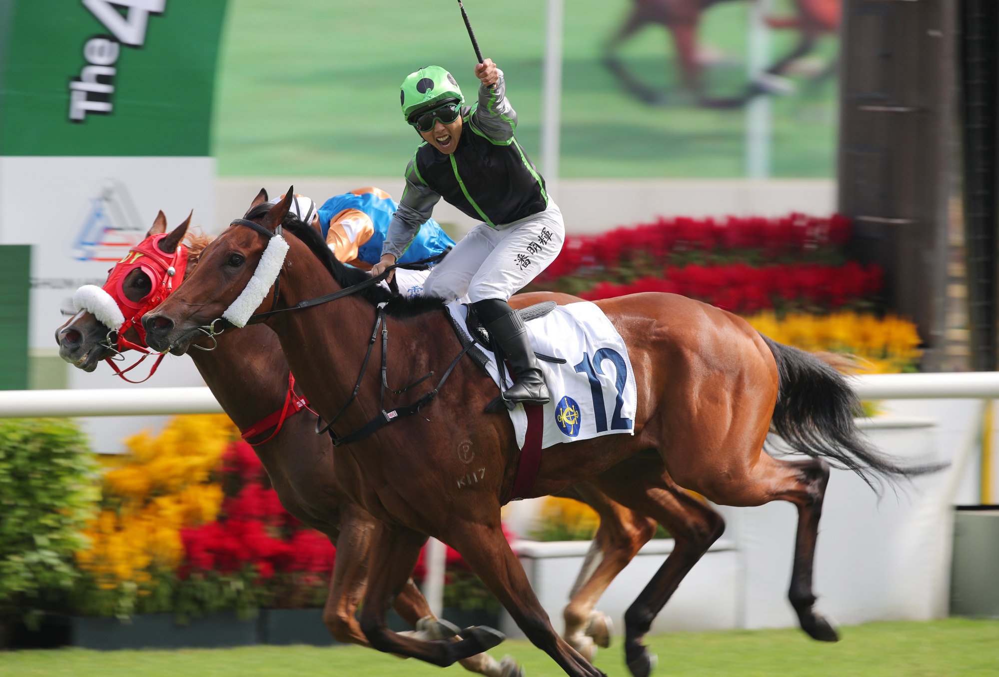 Matthew Poon salutes after an upset win on Time To Fire.