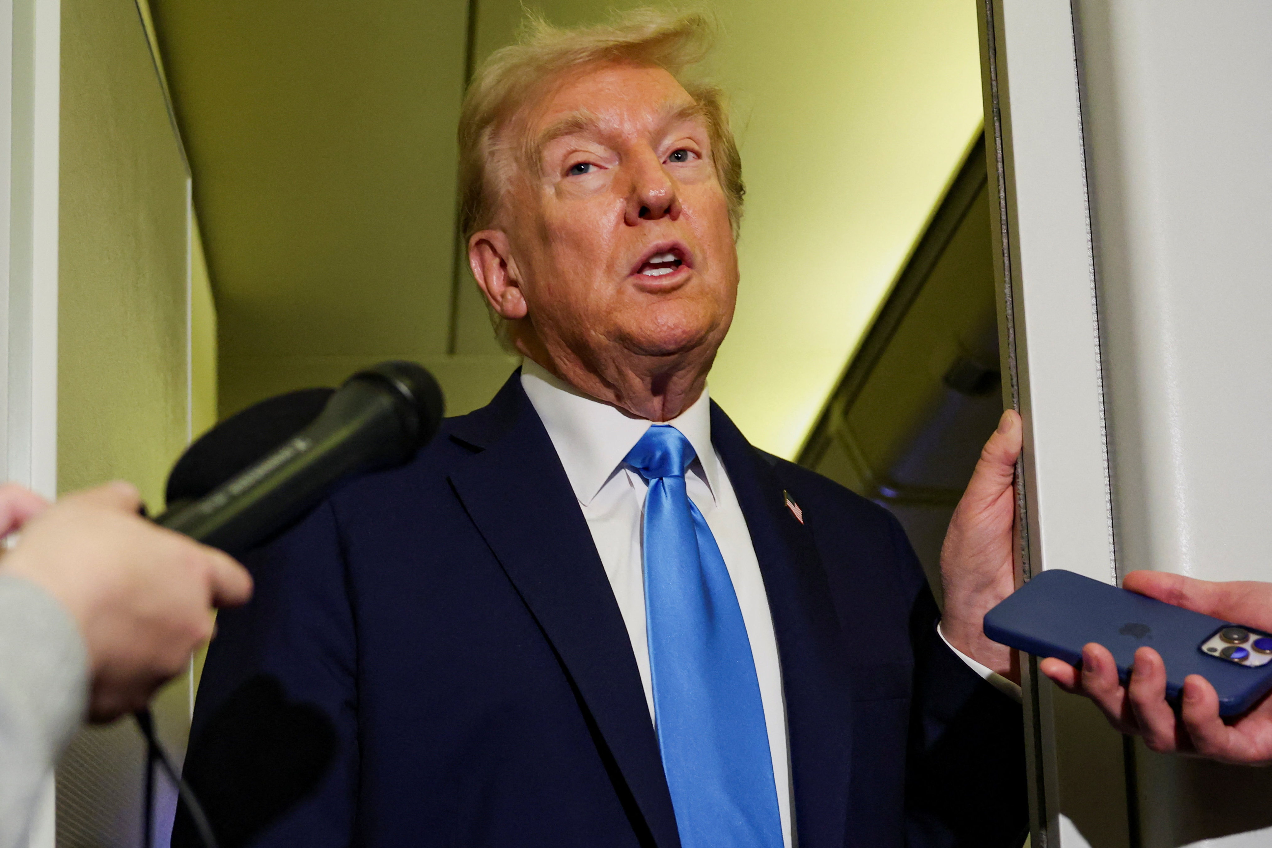 US President Donald Trump speaks to the media aboard Air Force One on Friday. Photo: Reuters