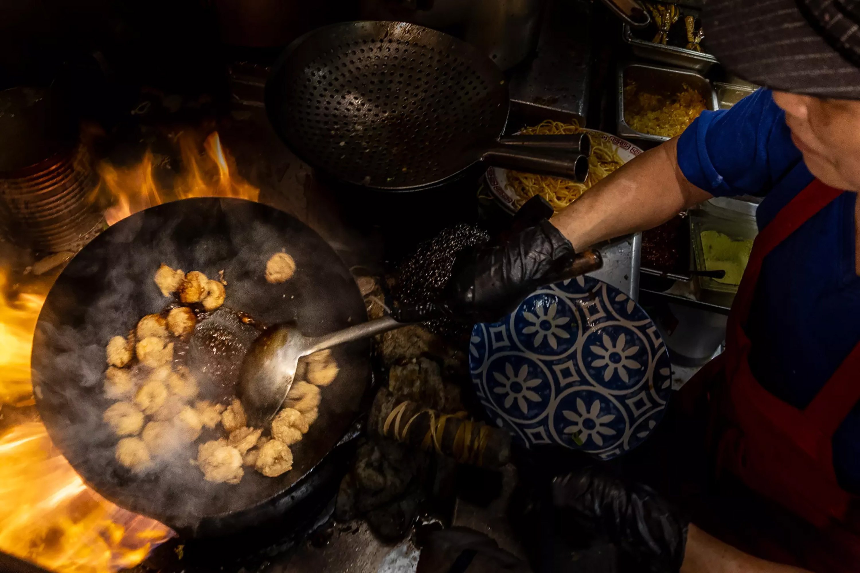Kuei Chu, 75, cooks shrimp in the quirky Merry Go Round restaurant in Lone Pine, California. Photo: TNS