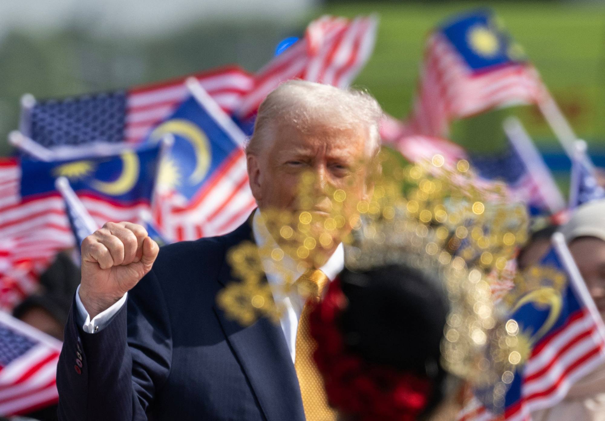 US President Donald Trump gestures before he departs on Air Force One from Kuala Lumpur on Monday after attending the Asean summit. Photo: AFP US President Donald Trump gestures before he departs on Air Force One from Kuala Lumpur on Monday after attending the Asean summit. Photo: AFP