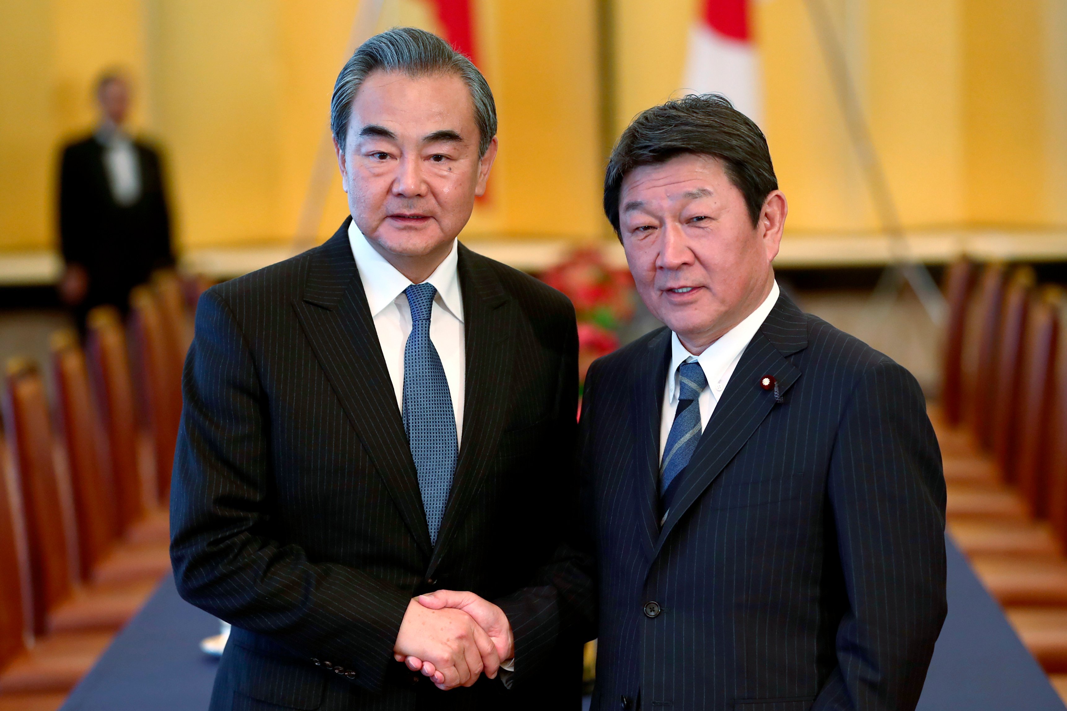Chinese Foreign Minister Wang Yi (left) spoke by phone with his Japanese counterpart Toshimitsu Motegi on Tuesday. Photo: AP