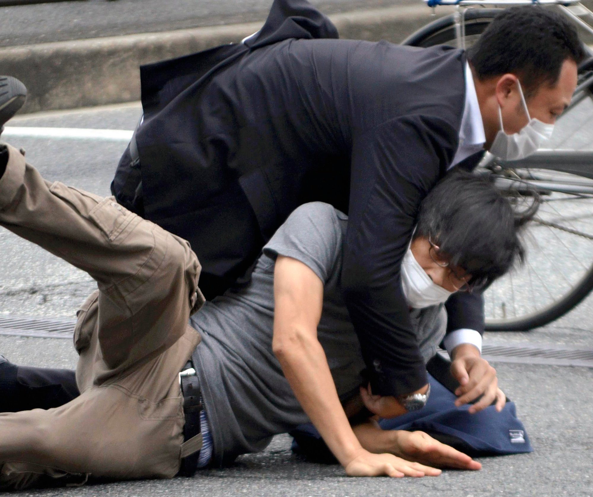 A police officer takes down Tetsuya Yamagami after he shoots Shinzo Abe during a campaign speech in Nara on July 8, 2022. Photo: The Yomiuri Shimbun/AP A police officer takes down Tetsuya Yamagami after he shoots Shinzo Abe during a campaign speech in Nara on July 8, 2022. Photo: The Yomiuri Shimbun/AP
