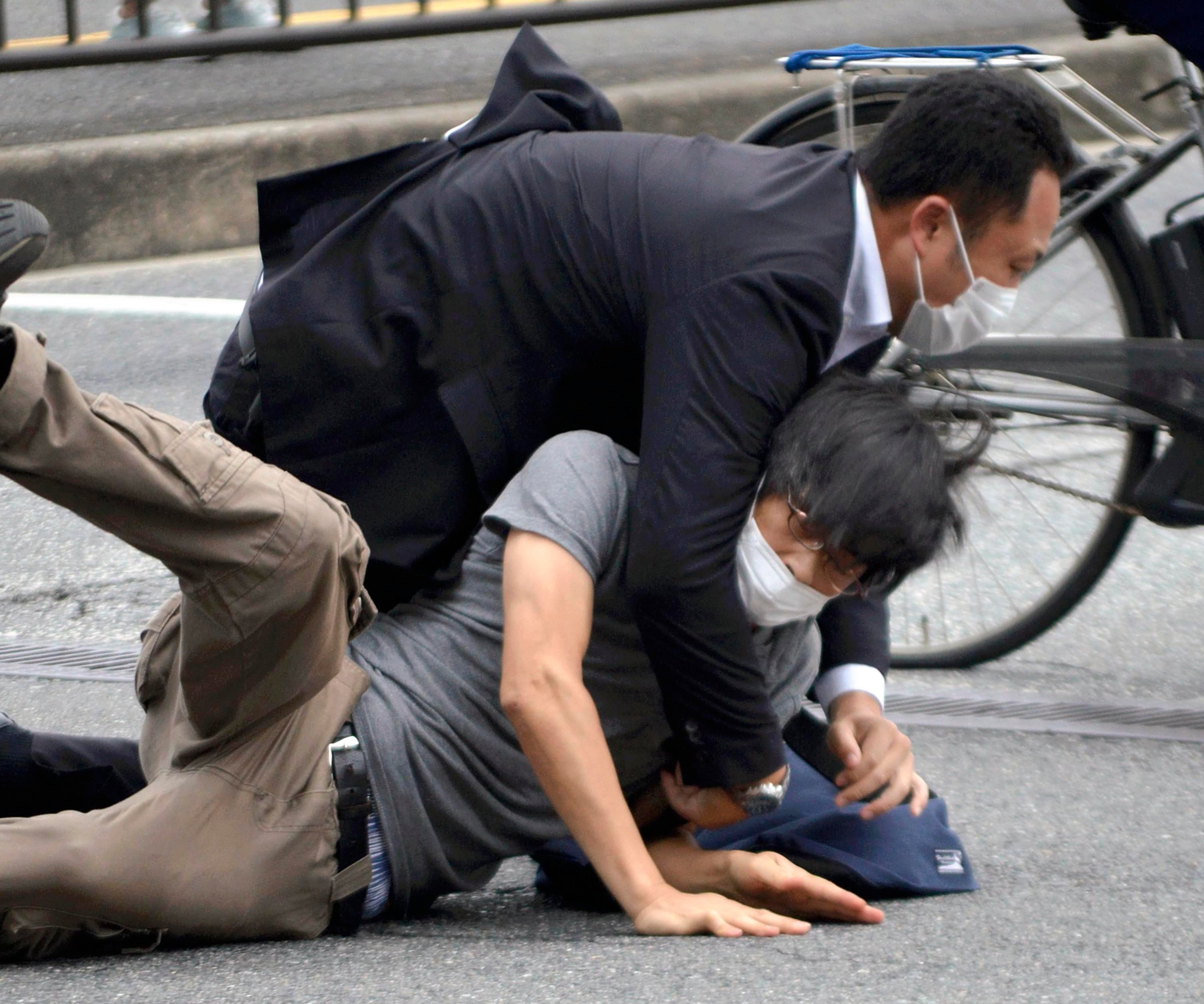 A police officer takes down Tetsuya Yamagami after he shoots Shinzo Abe during a campaign speech in Nara on July 8, 2022. Photo: The Yomiuri Shimbun/AP