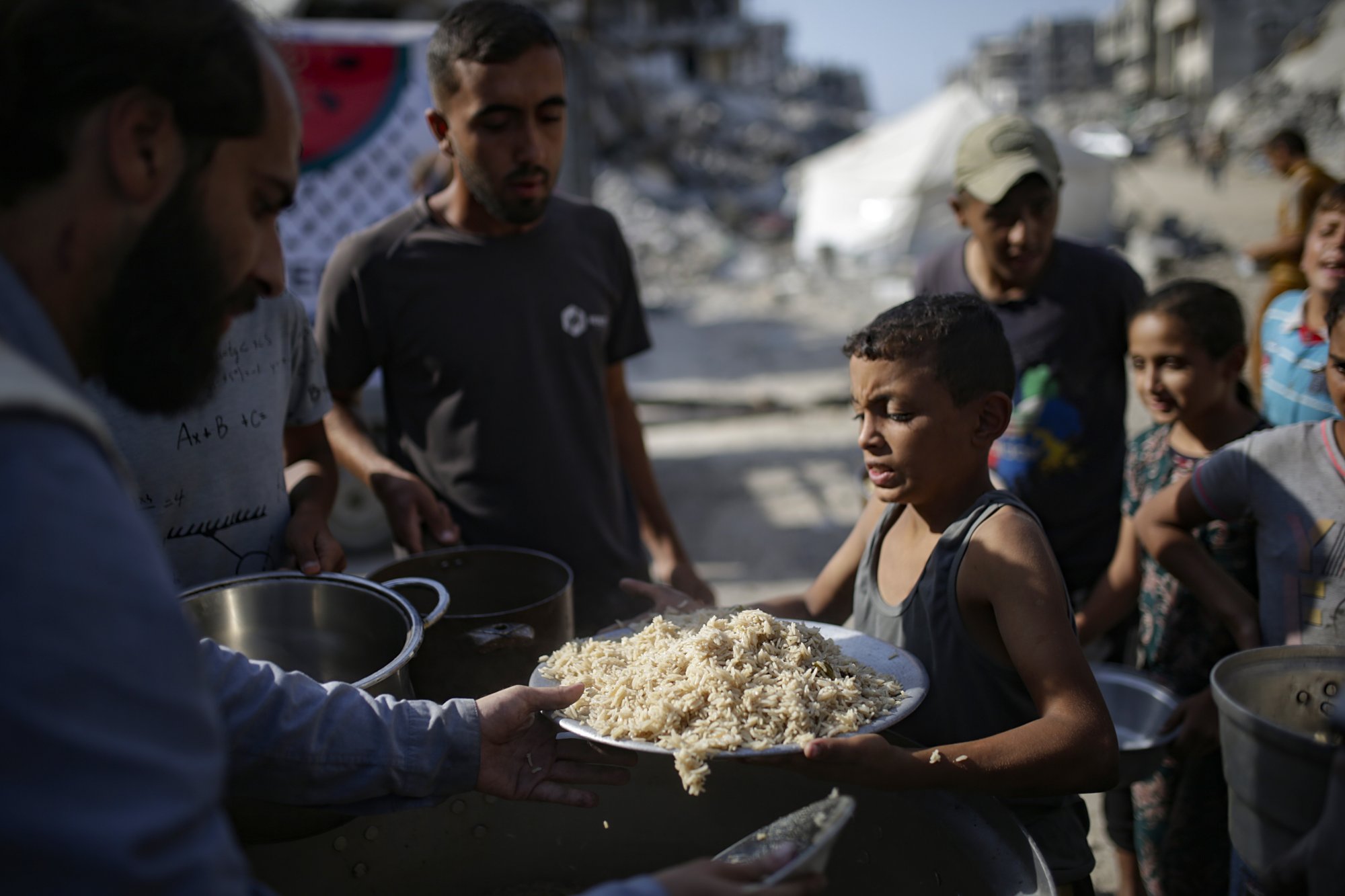 A Palestinian boy receives food from a charity kitchen, in Gaza City, on October 23, amid a ceasefire between Israel and Hamas. Photo: EPA A Palestinian boy receives food from a charity kitchen, in Gaza City, on October 23, amid a ceasefire between Israel and Hamas. Photo: EPA