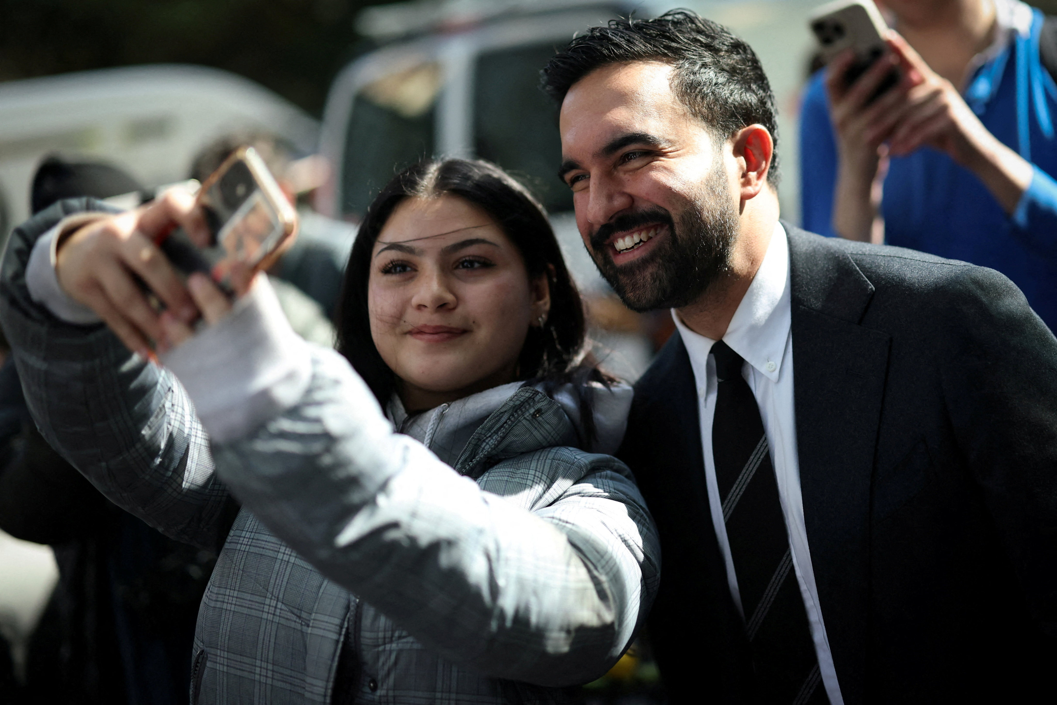 Democratic candidate for New York City mayor, Zohran Mamdani, poses for a selfie with a supporter while campaigning. Photo: Reuters
