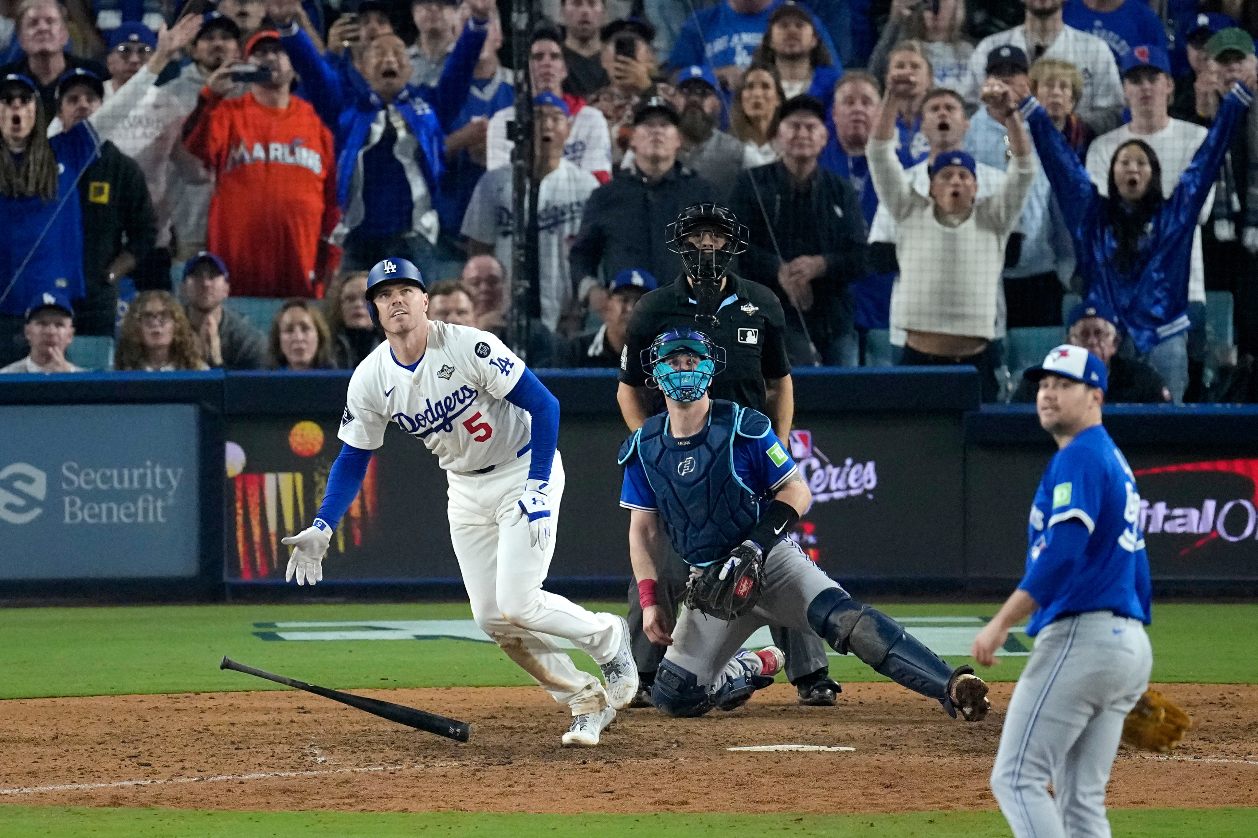 LA Dodgers’ Freddie Freeman (left) watches his walk-off home run leave the park during the 18th inning in game three of baseball’s World Series against the Toronto Blue Jays on Monday in Los Angeles. Photo: AP