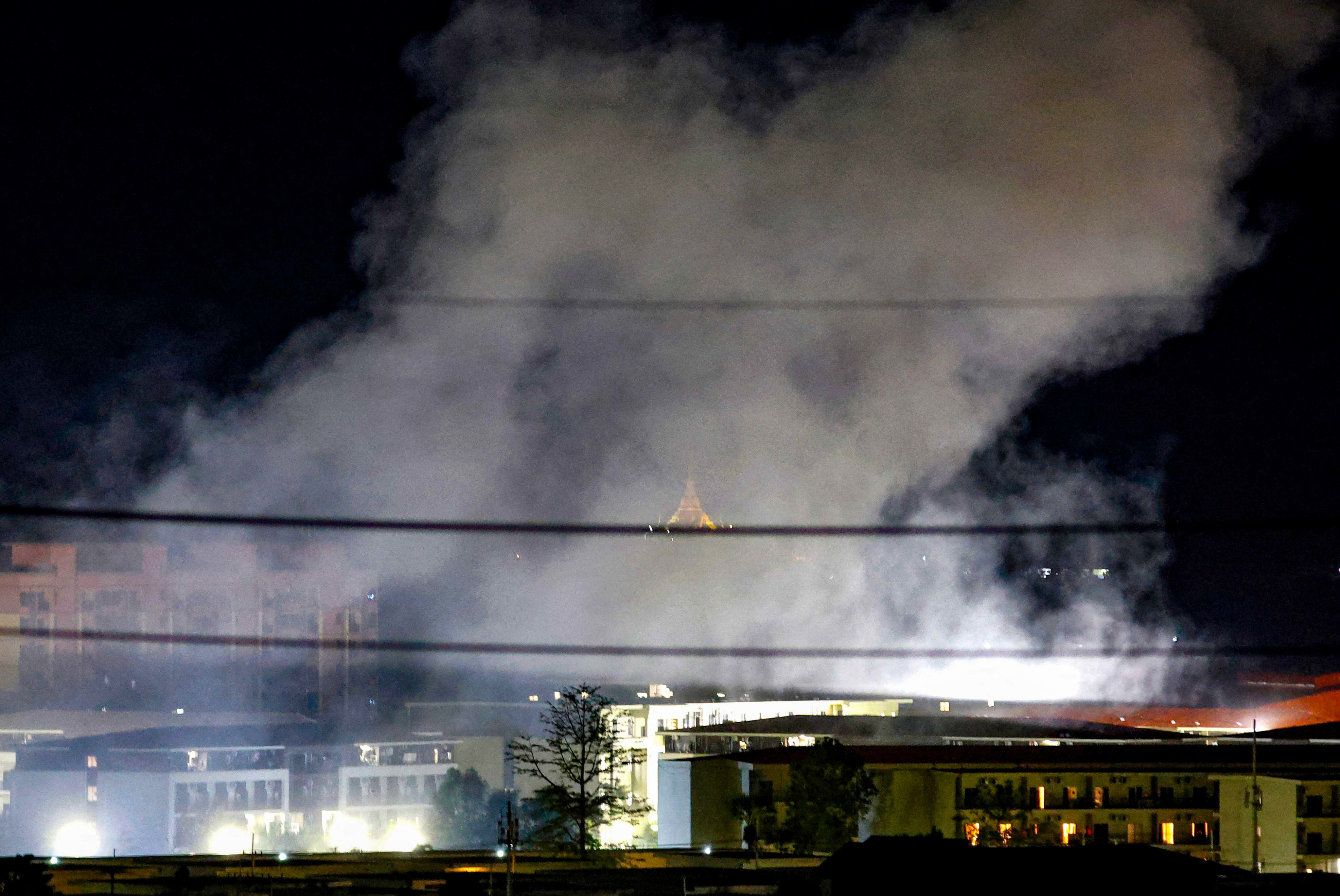 Smoke rises over buildings following an explosion in the KK Park compound. More than 1,500 people have fled from Myanmar into Thailand this week after the Myanmar military raided one of the country’s largest scam centres. Photo: AFP