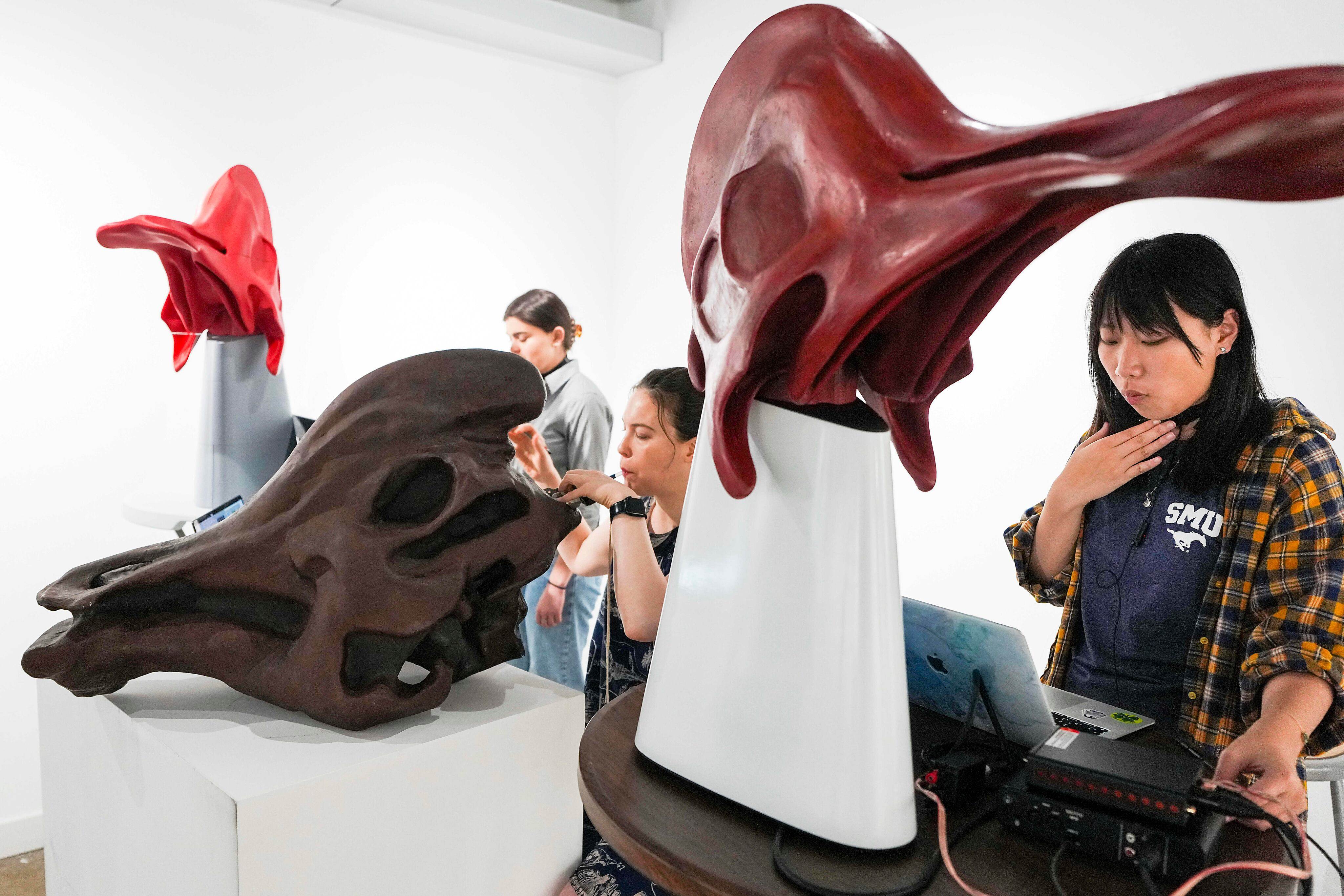 Professor Courtney Brown (centre) and students play musical instruments based on dinosaur skulls that Brown created. Photos: TNS