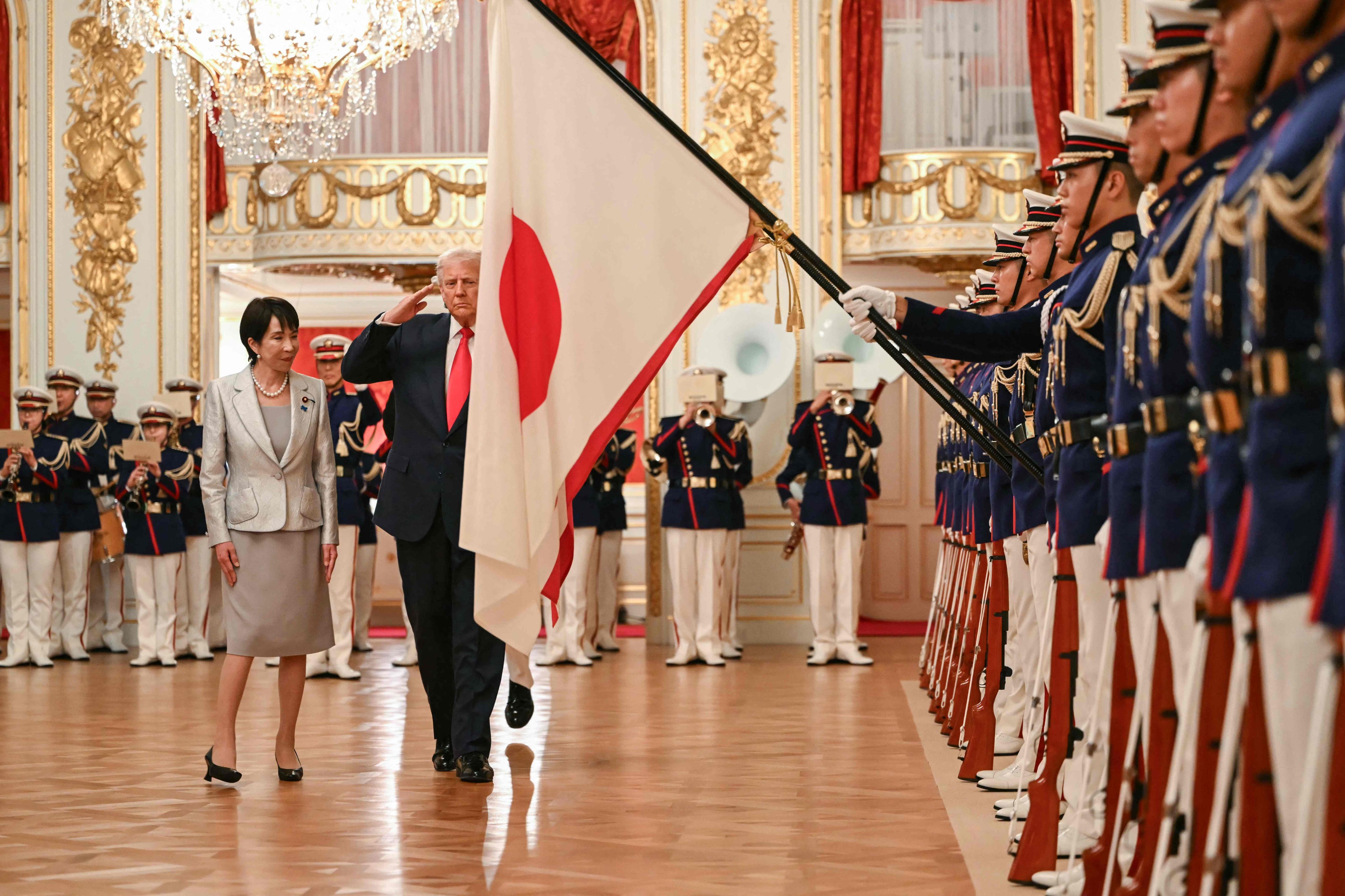 Japan’s Prime Minister Sanae Takaichi and US President Donald Trump review an honour guard in Tokyo on Tuesday. Photo: AFP