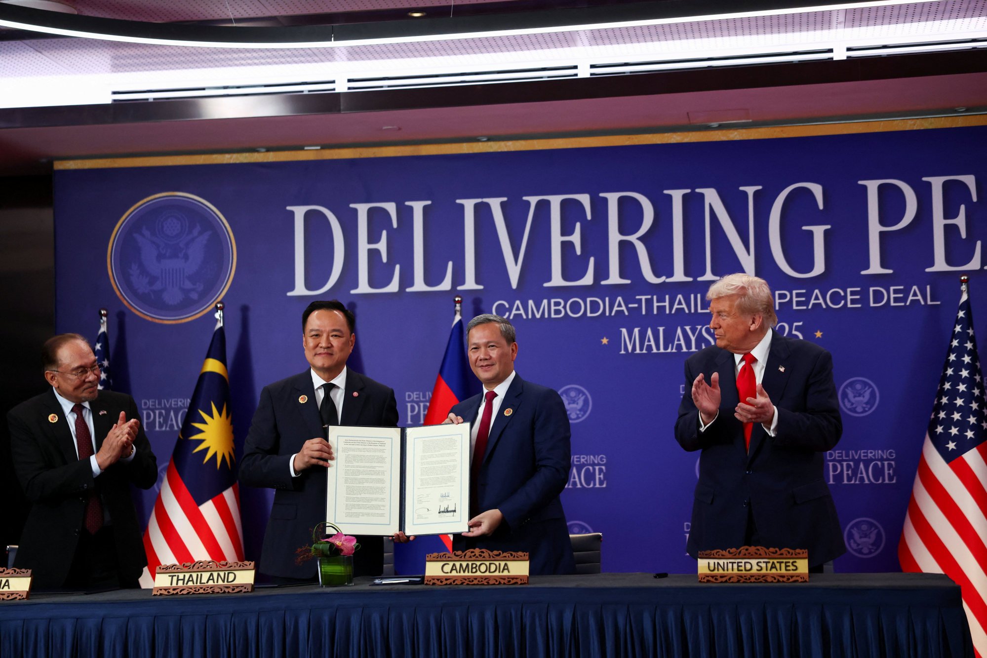 Malaysia’s Prime Minister Anwar Ibrahim and US President Donald Trump applaud during the ceremonial peace deal between Thailand and Cambodia on the sidelines of the Asean summit in Kuala Lumpur on Sunday. Photo: Reuters Malaysia’s Prime Minister Anwar Ibrahim and US President Donald Trump applaud during the ceremonial peace deal between Thailand and Cambodia on the sidelines of the Asean summit in Kuala Lumpur on Sunday. Photo: Reuters
