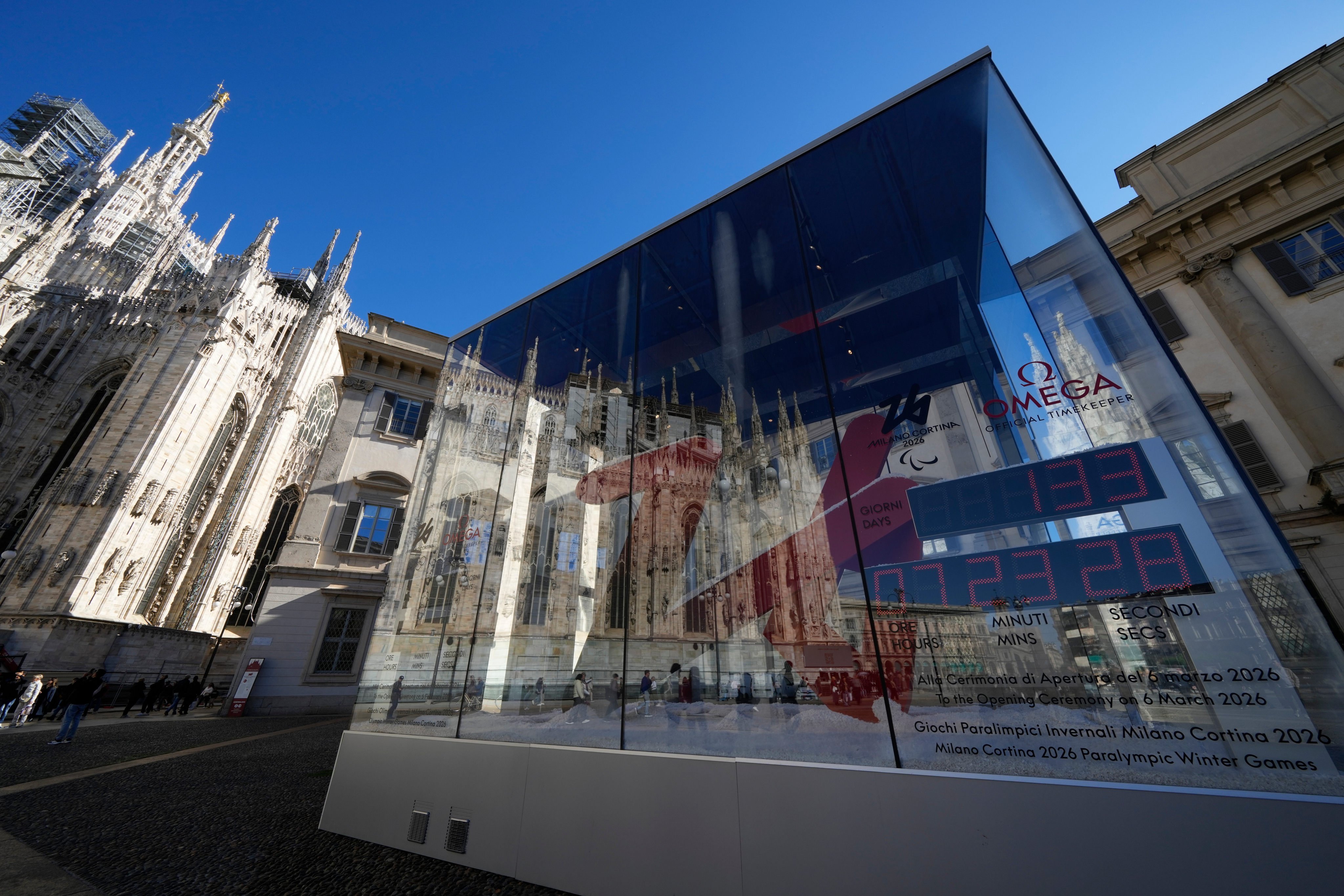 The Duomo cathedral is reflected in the glass of the Winter Olympics countdown watch in Milan on October 24. Photo: AP