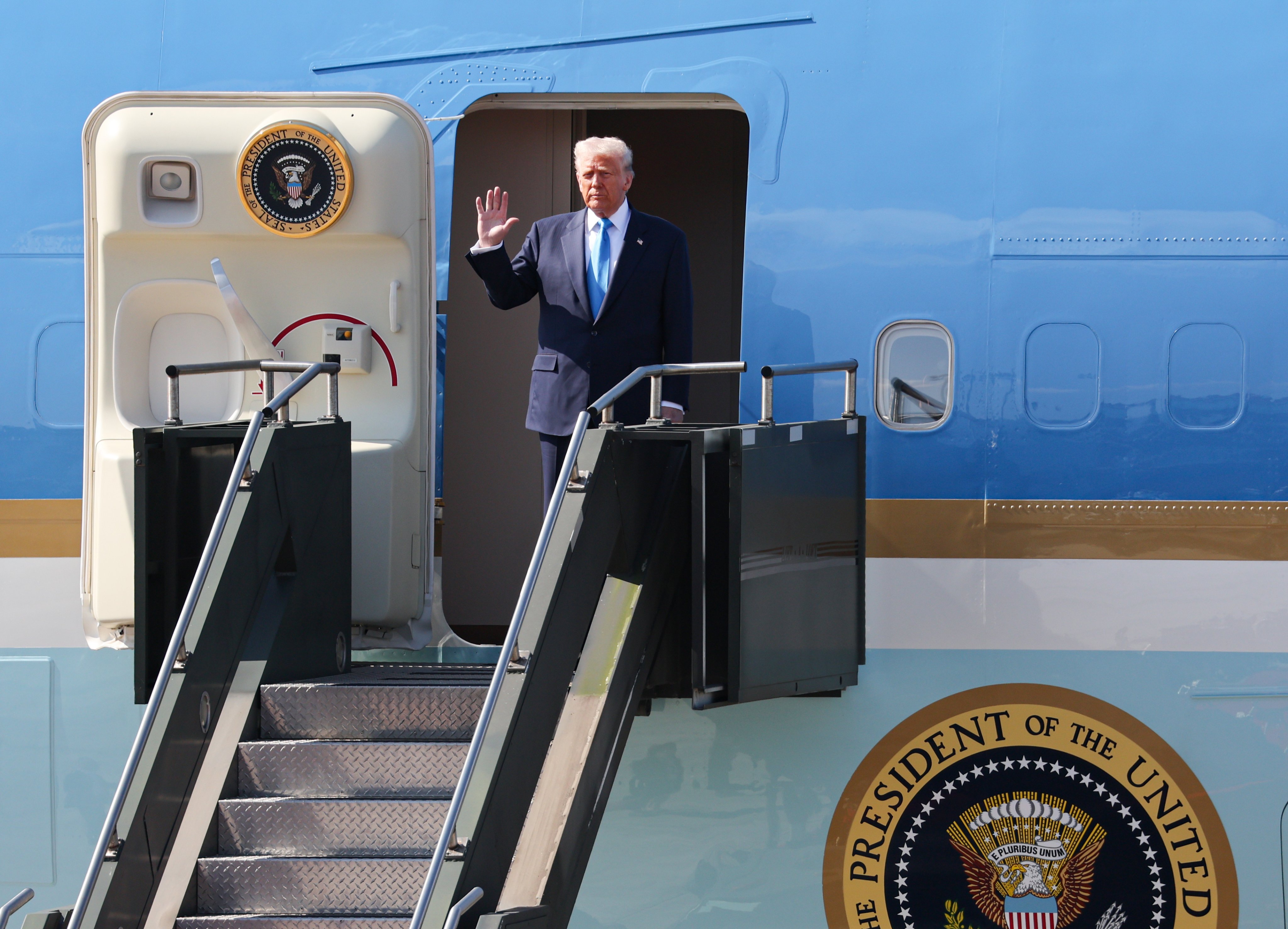 US President Donald Trump waves as he disembarks from Air Force One at Gimhae International Airport in Busan, South Korea, on Wednesday. Photo: EPA/Yonhap