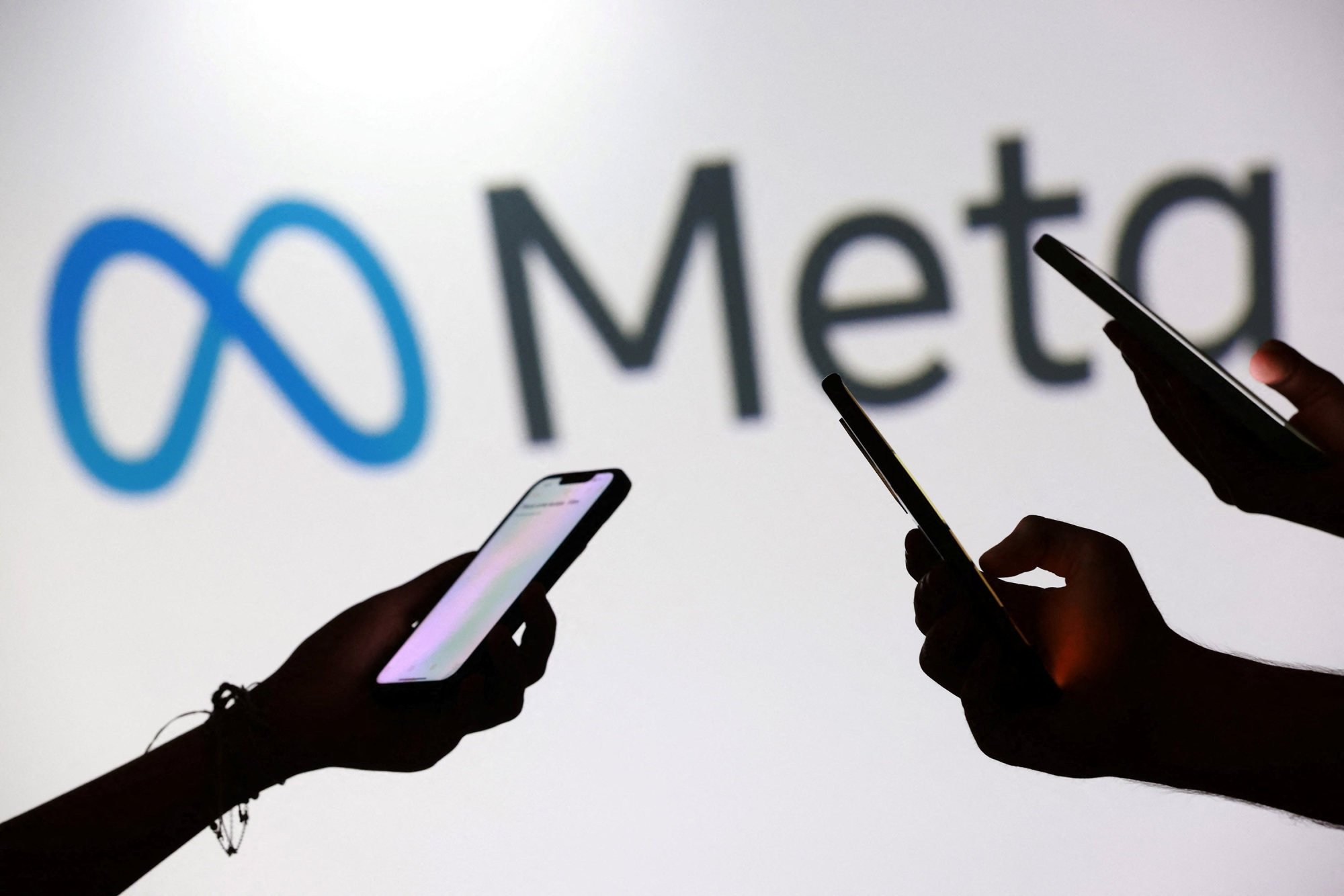 Teenagers holding smartphones in front of a Meta logo. Meta says it has been improving its internal youth safety regulations and anti-scam protocols. Photo: Reuters Teenagers holding smartphones in front of a Meta logo. Meta says it has been improving its internal youth safety regulations and anti-scam protocols. Photo: Reuters