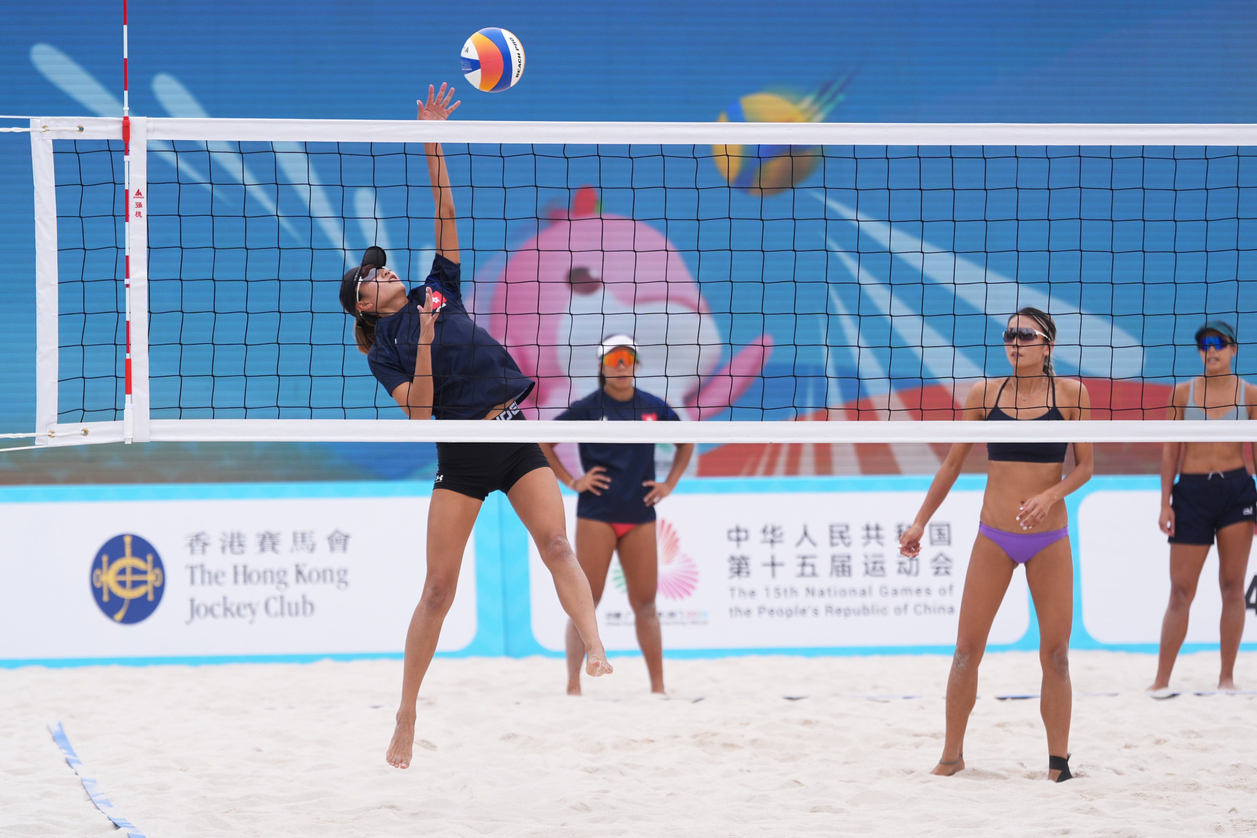 Hong Kong beach volleyball players To Wing-man (left) and her twin sister To Wing-tung (second from right) testing out the courts at Victoria Park in Causeway Bay on Wednesday. Photo: Eugene Lee